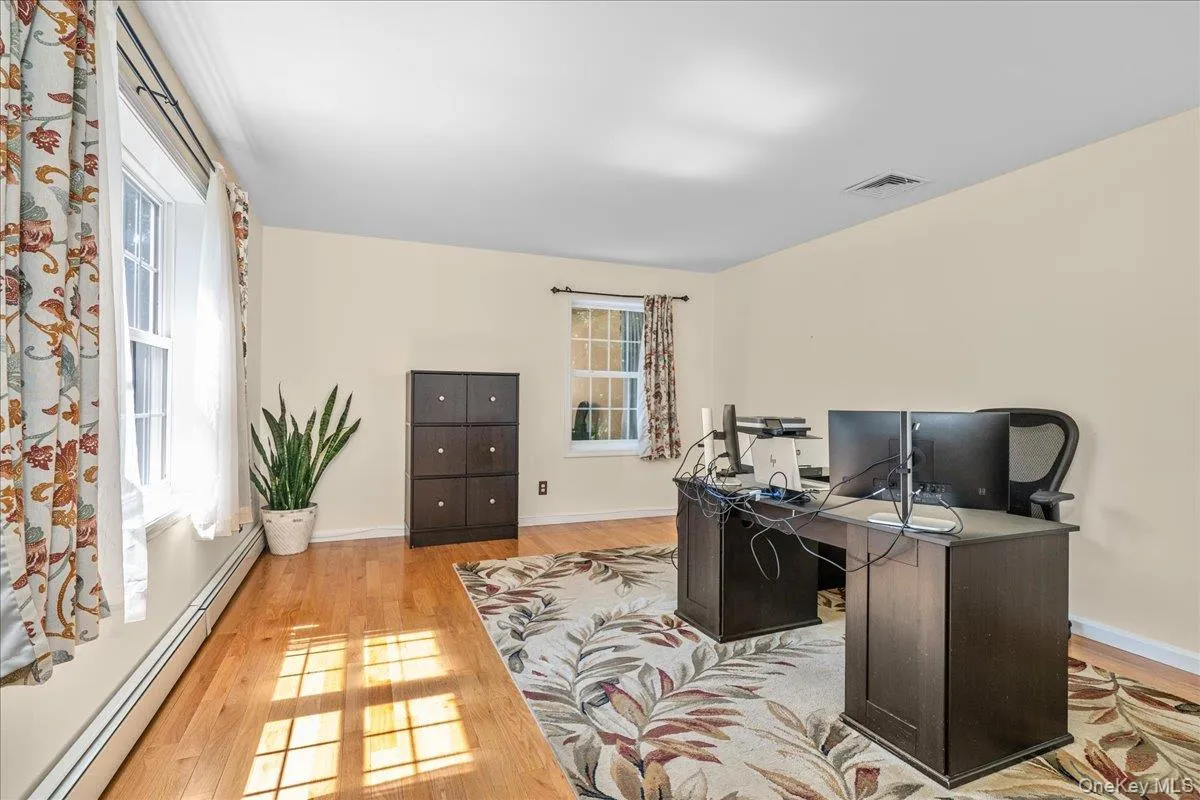 Hardwood flooring complements neutral wall tones and white trim. Hardwood flooring complements neutral wall tones and white trim.
