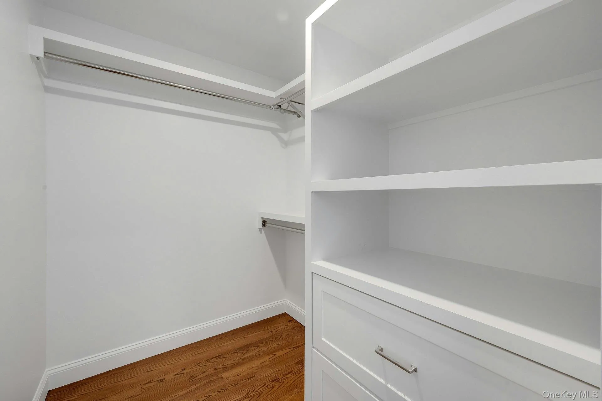 Primary bedroom walk-in closet Primary bedroom walk-in closet