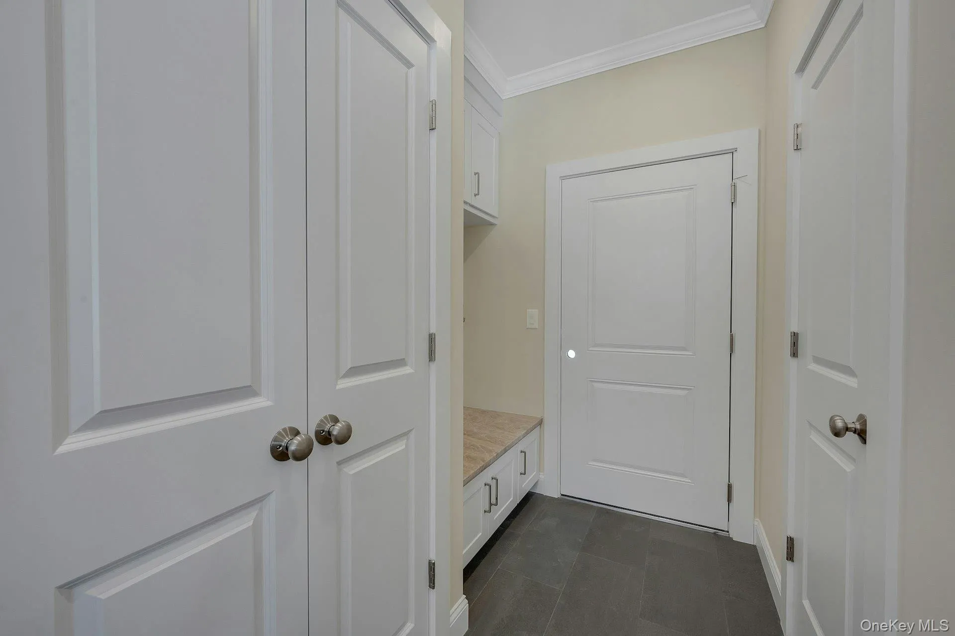 Hallway located off of the entrance to the 2 car garage Hallway located off of the entrance to the 2 car garage