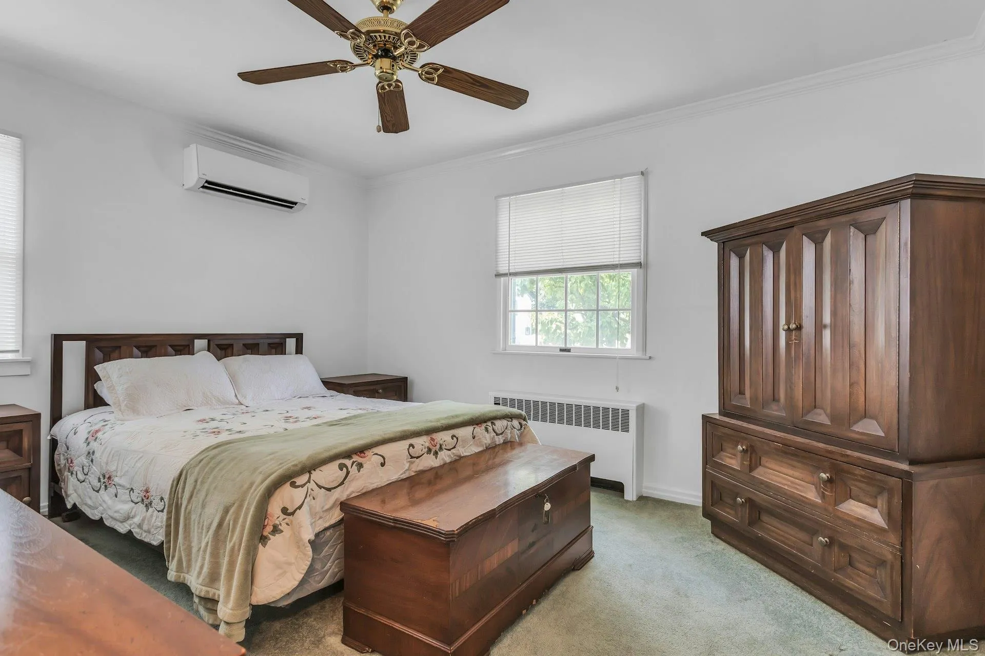 White-painted room featuring a window with blinds, baseboard heating, and a wall-mounted air conditioning unit White-painted room featuring a window with blinds, baseboard heating, and a wall-mounted air conditioning unit