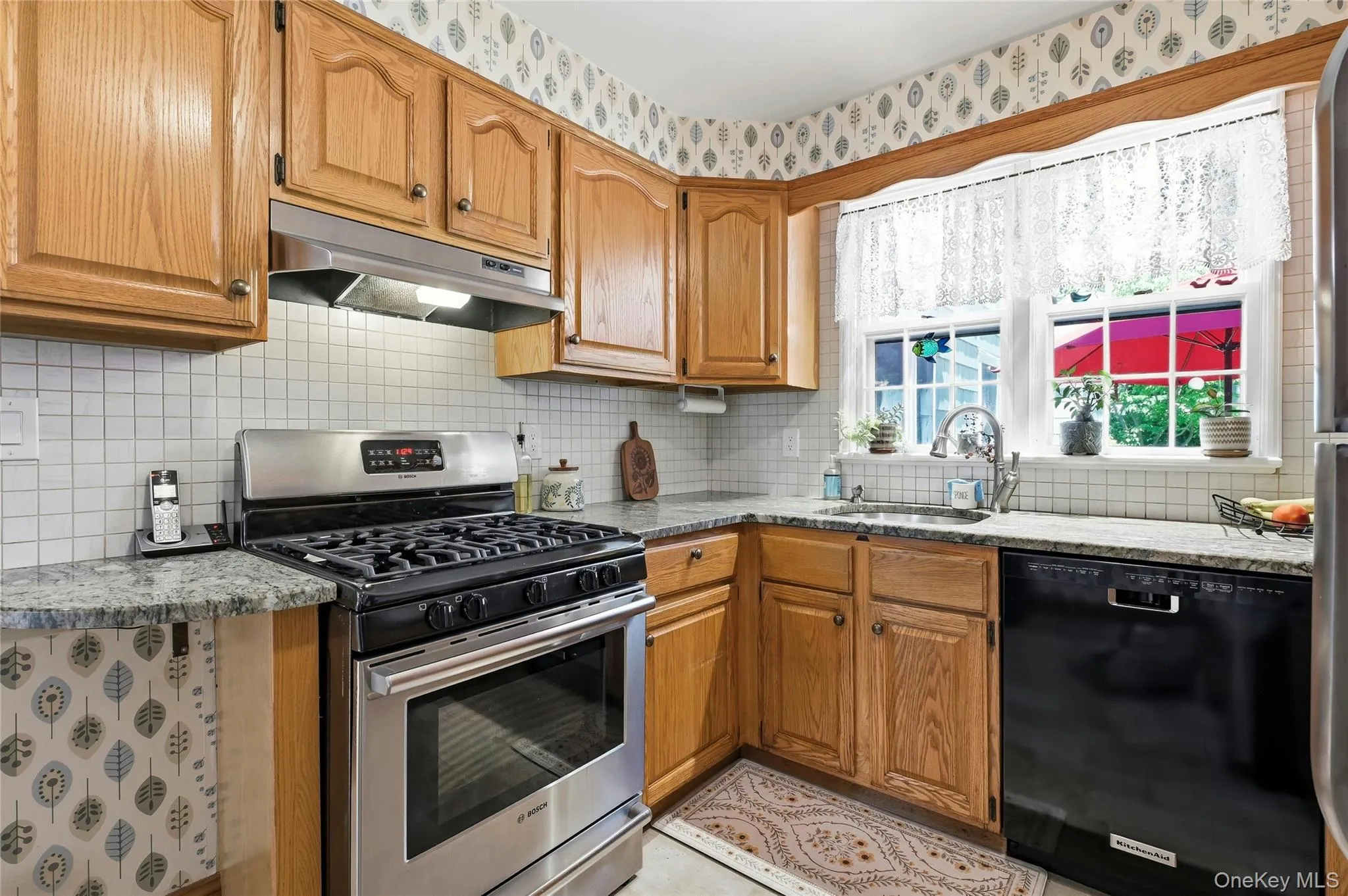 Features attractive wood cabinetry and granite counter tops Features attractive wood cabinetry and granite counter tops