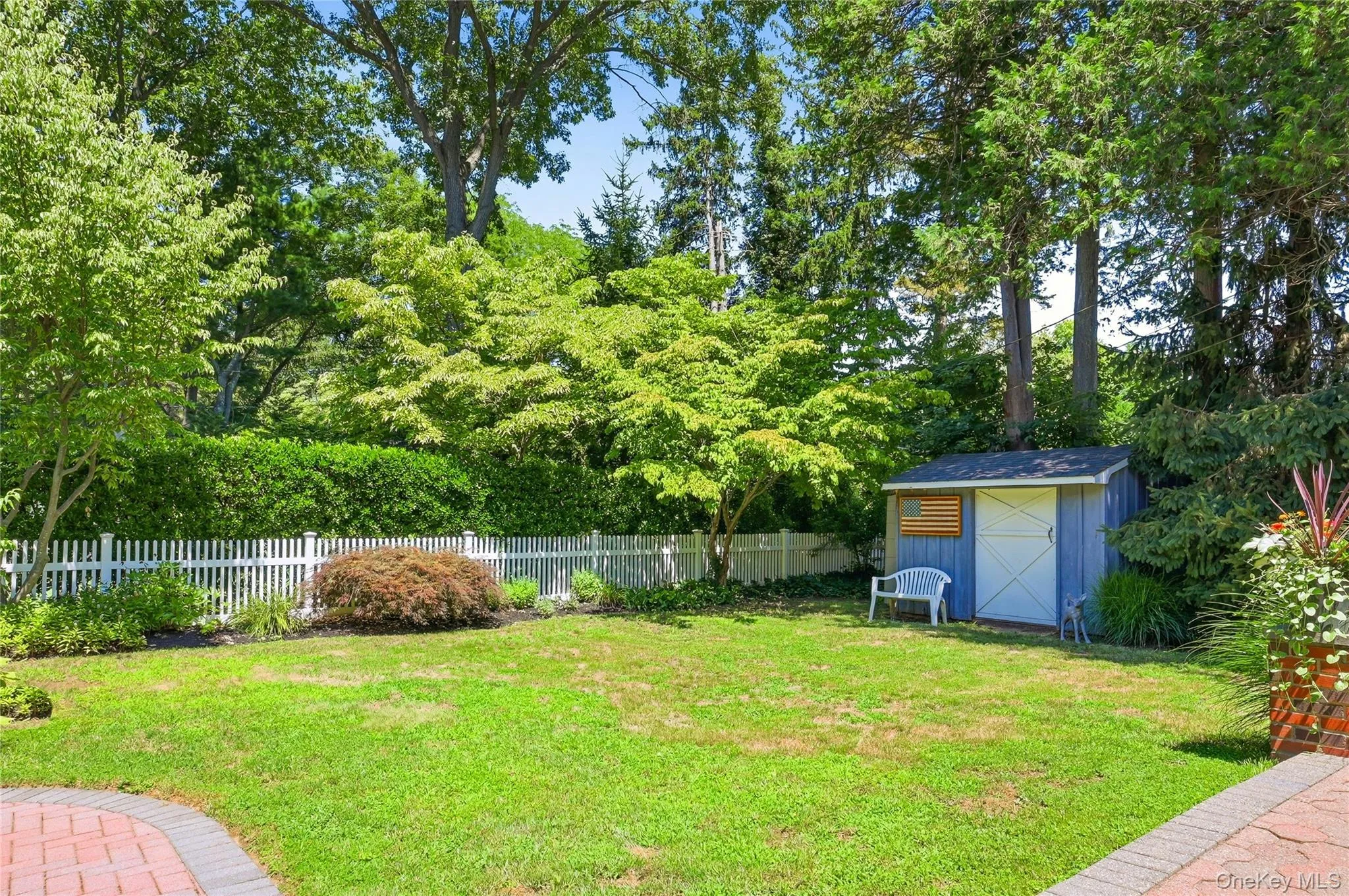 Grassy area off of patio with storage shedy Grassy area off of patio with storage shedy