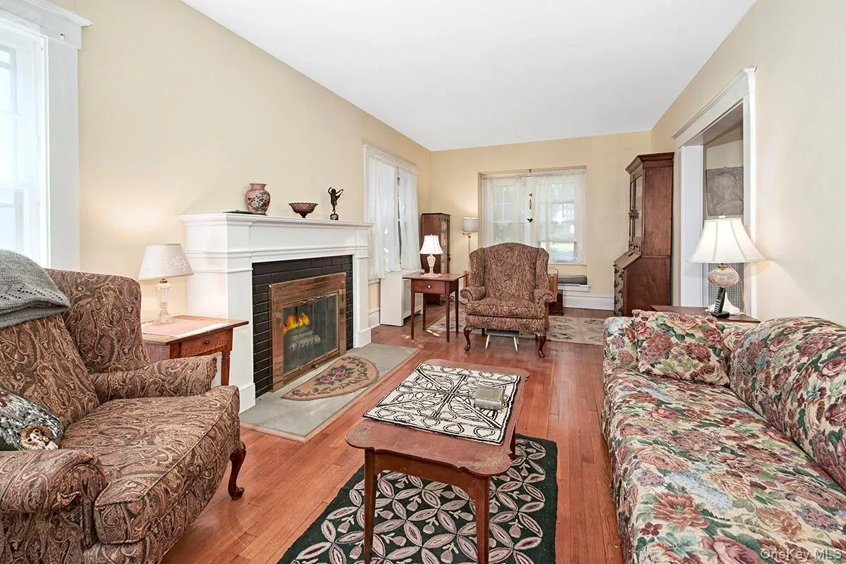 Classic white mantel fireplace with a dark surround and hearth. Classic white mantel fireplace with a dark surround and hearth.