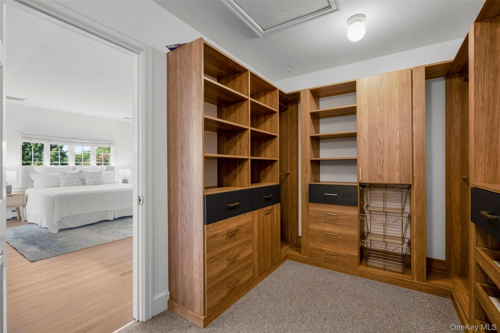 Walk-in custom fitted closet in primary Walk-in custom fitted closet in primary