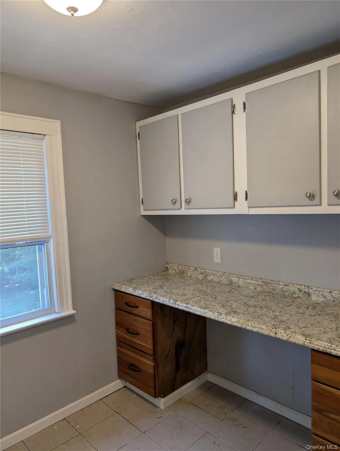 Laundry folding area with overhead cabinets Laundry folding area with overhead cabinets