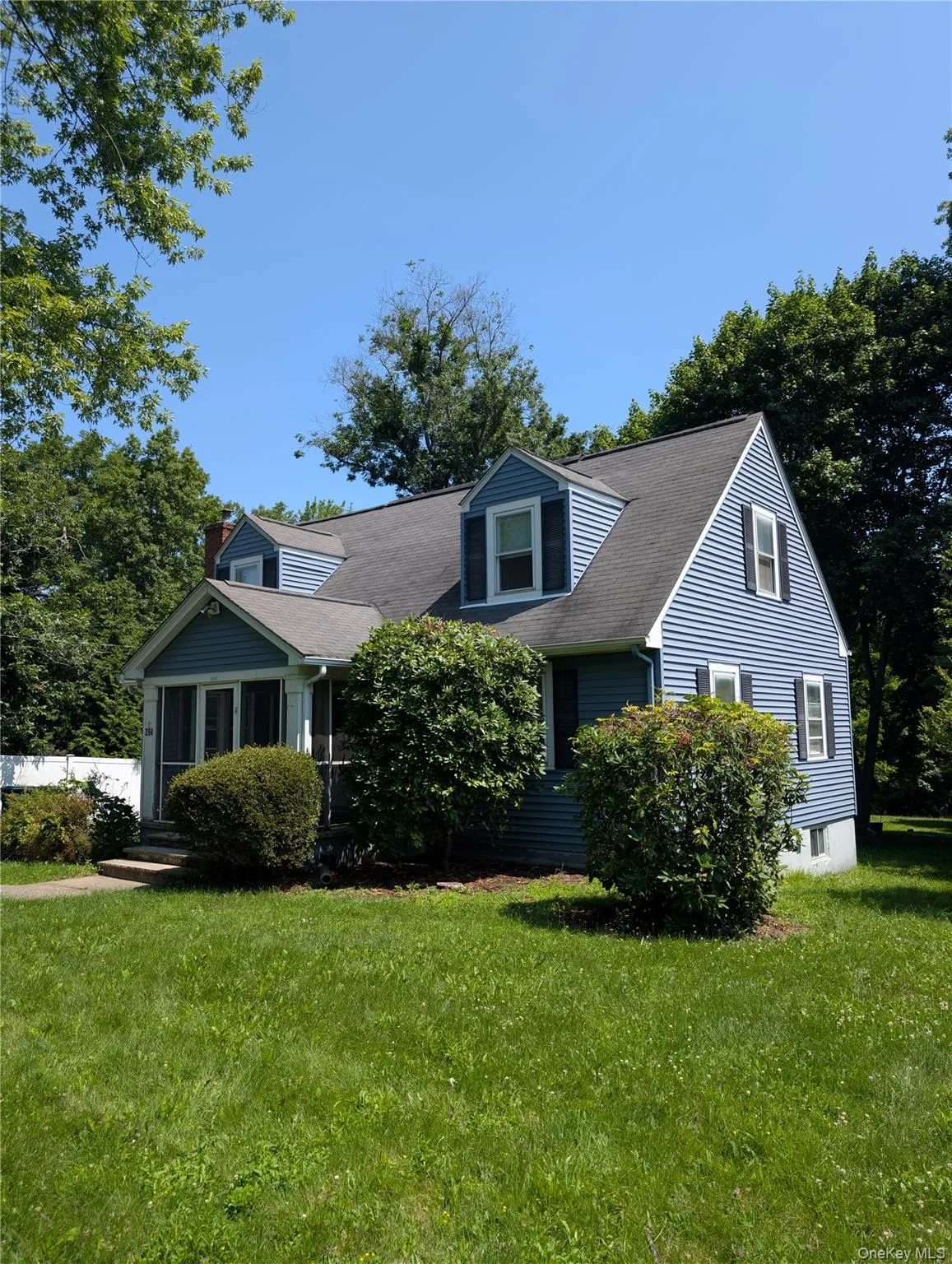 Located in a Cape Cod with blue siding and dormer windows, enter through a screened porch. Located in a Cape Cod with blue siding and dormer windows, enter through a screened porch.