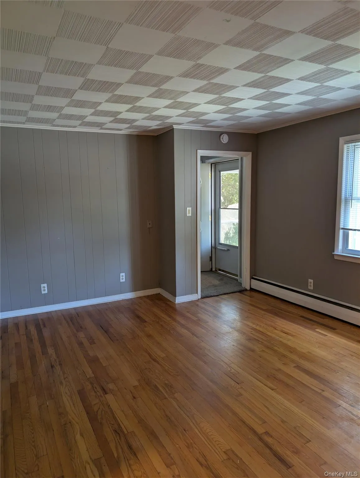 Hardwood flooring extending throughout complemented by custom ceiling tiles Hardwood flooring extending throughout complemented by custom ceiling tiles