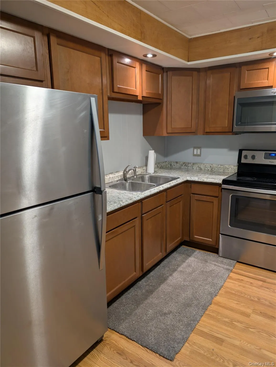 Kitchen features wood-finish flooring and solid wood cabinetry, recessed lighting Kitchen features wood-finish flooring and solid wood cabinetry, recessed lighting