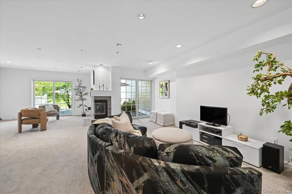 Versatile walkout lower level (620 sqft) w/2 sided wood burning fireplace & 2 sets of glass sliding doors to Belgian block patio Versatile walkout lower level (620 sqft) w/2 sided wood burning fireplace & 2 sets of glass sliding doors to Belgian block patio