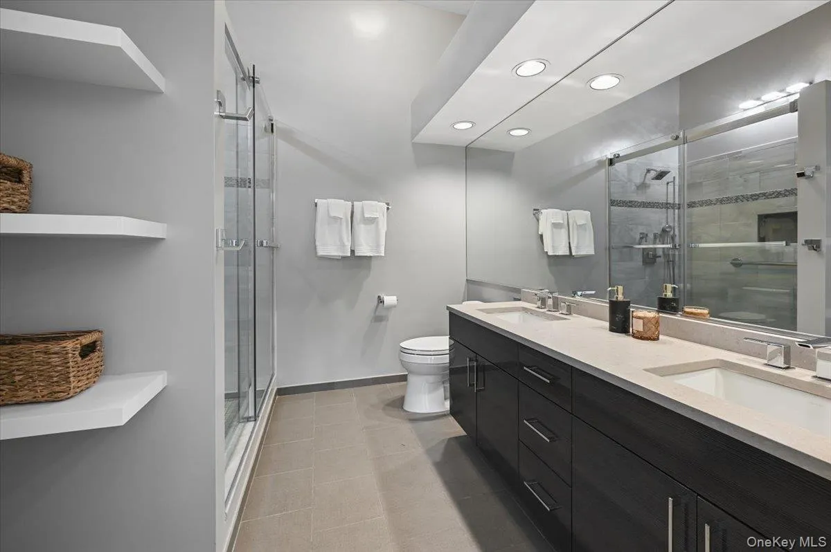 Renovated Primary bathroom with spa like features; dual vanity, shower and storage Renovated Primary bathroom with spa like features; dual vanity, shower and storage