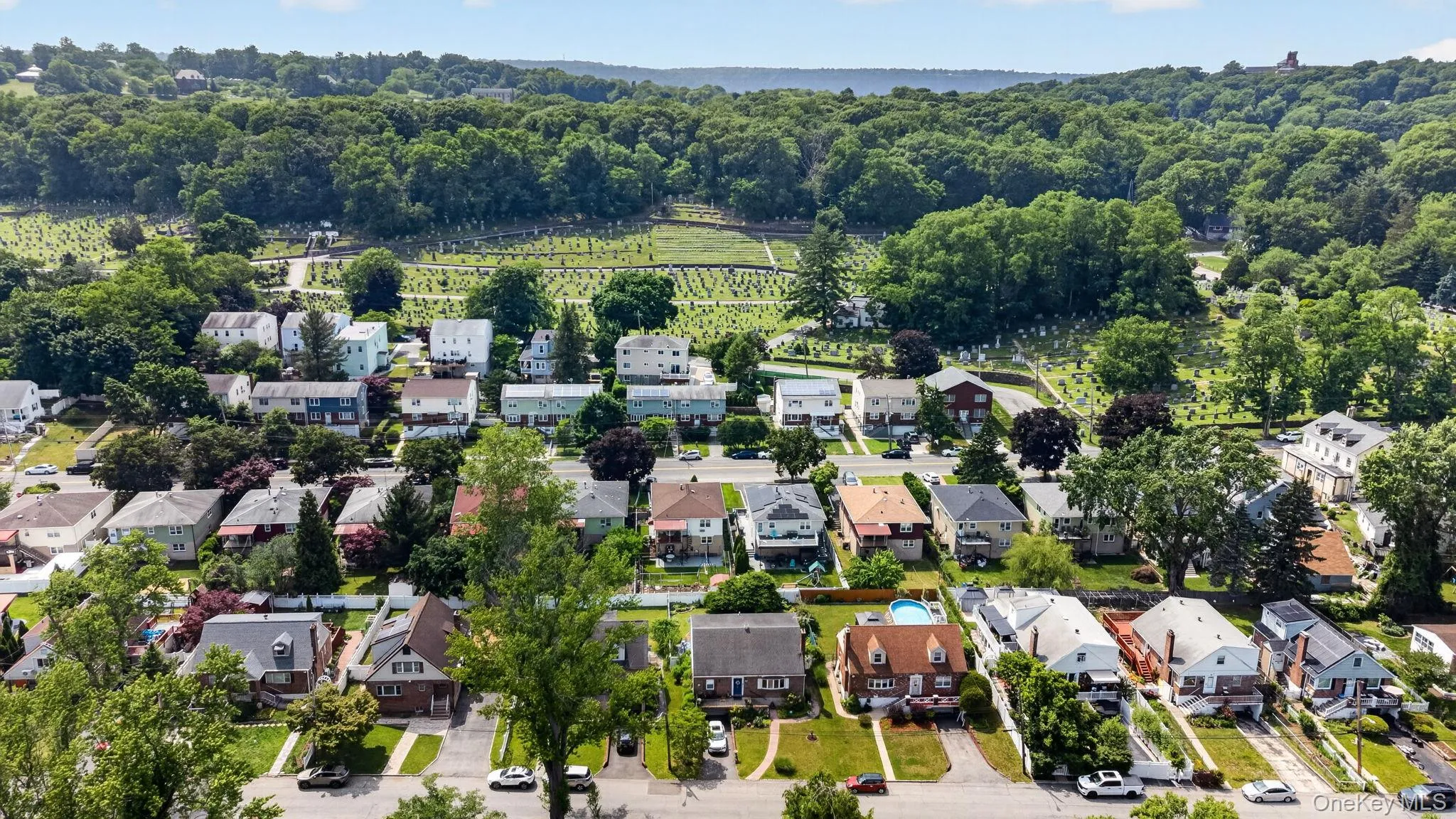Aerial perspective showcasing a residential neighborhood with diverse architectural styles, mature trees, and paved roadways Aerial perspective showcasing a residential neighborhood with diverse architectural styles, mature trees, and paved roadways