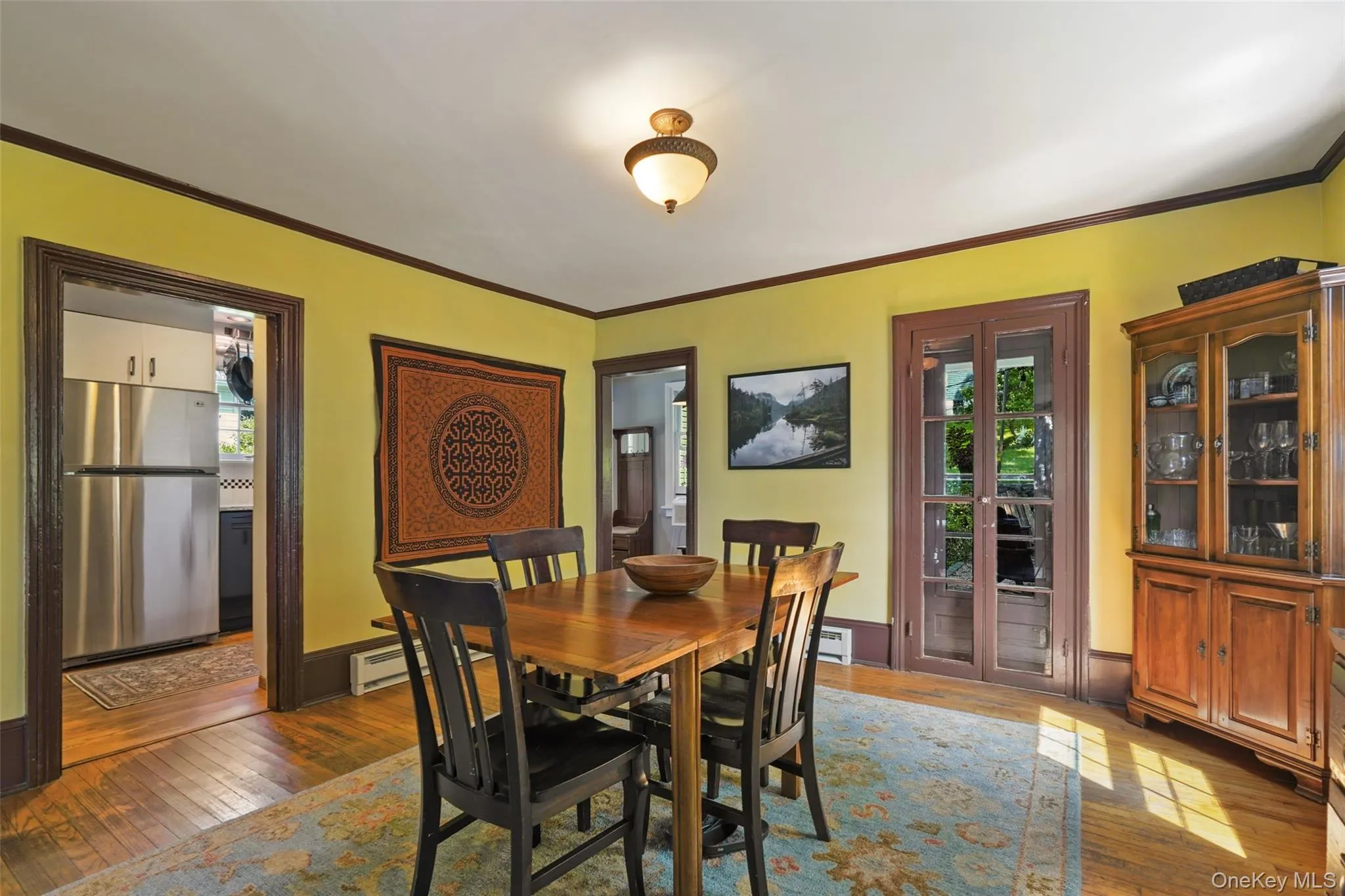 Dining with doors to kitchen, entryway, and out to patio Dining with doors to kitchen, entryway, and out to patio