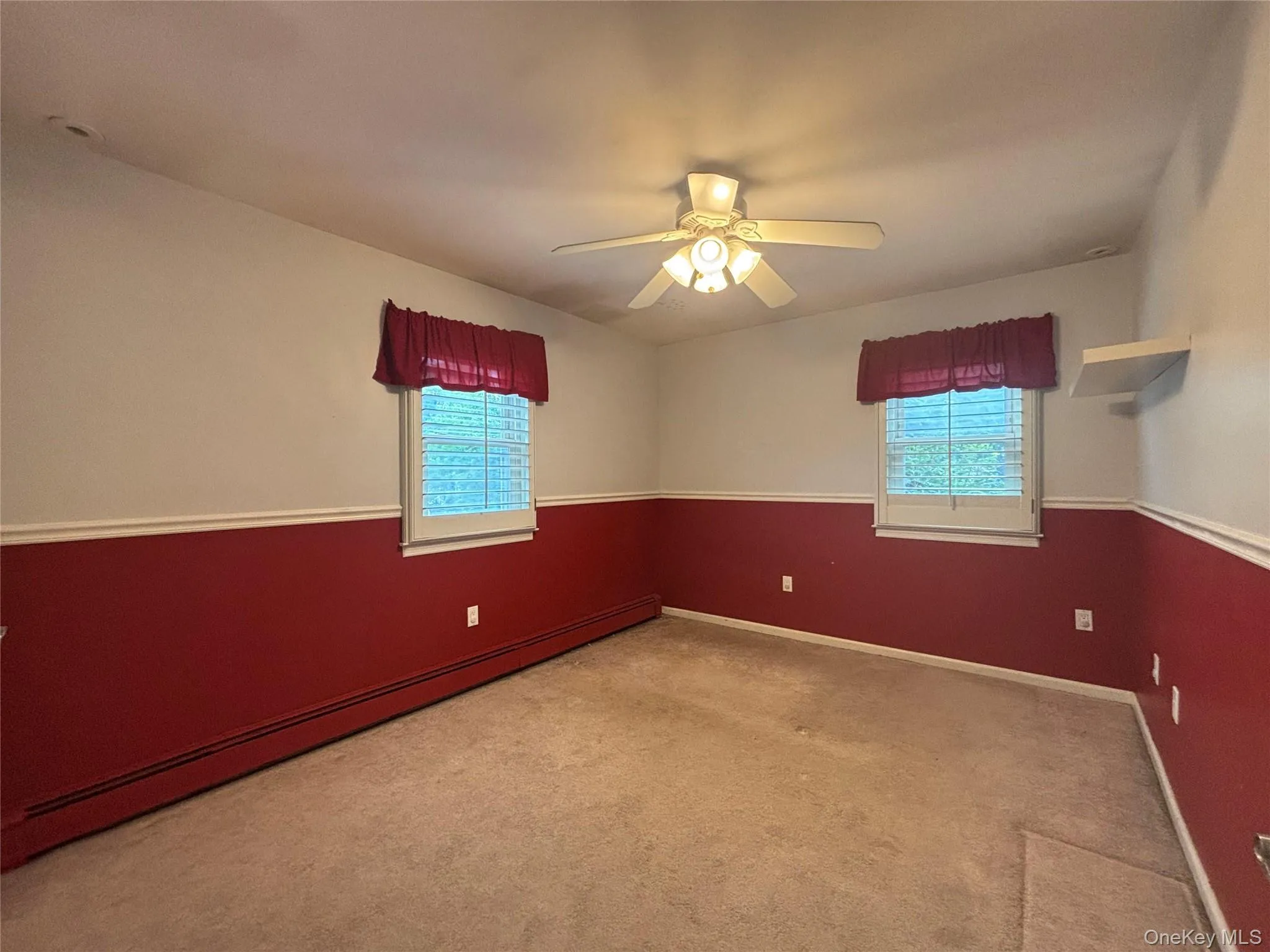 Neutral carpeted flooring with white baseboards Neutral carpeted flooring with white baseboards