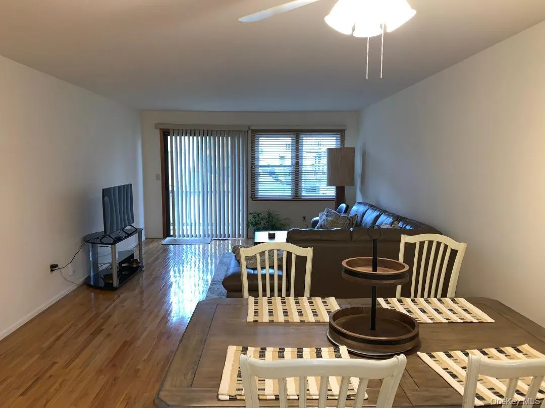 Huge living room which opens to formal dining area and sliders to a trex deck overlooking trees Huge living room which opens to formal dining area and sliders to a trex deck overlooking trees