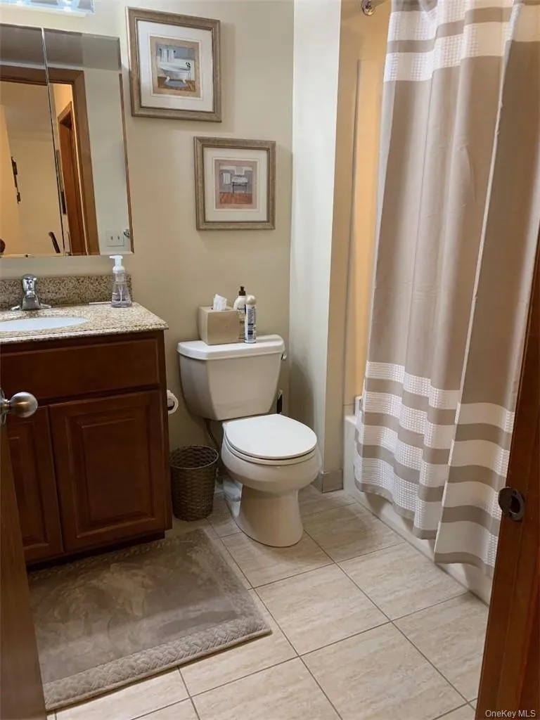 Pretty updated bathroom with a walk in shower stall. Pretty updated bathroom with a walk in shower stall.