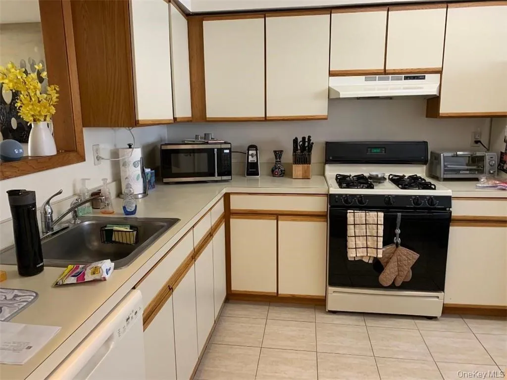 There's a spacious eat in kitchen with lots of cabinet and counterspace, a pretty ceramic tile floor and updated appliances There's a spacious eat in kitchen with lots of cabinet and counterspace, a pretty ceramic tile floor and updated appliances
