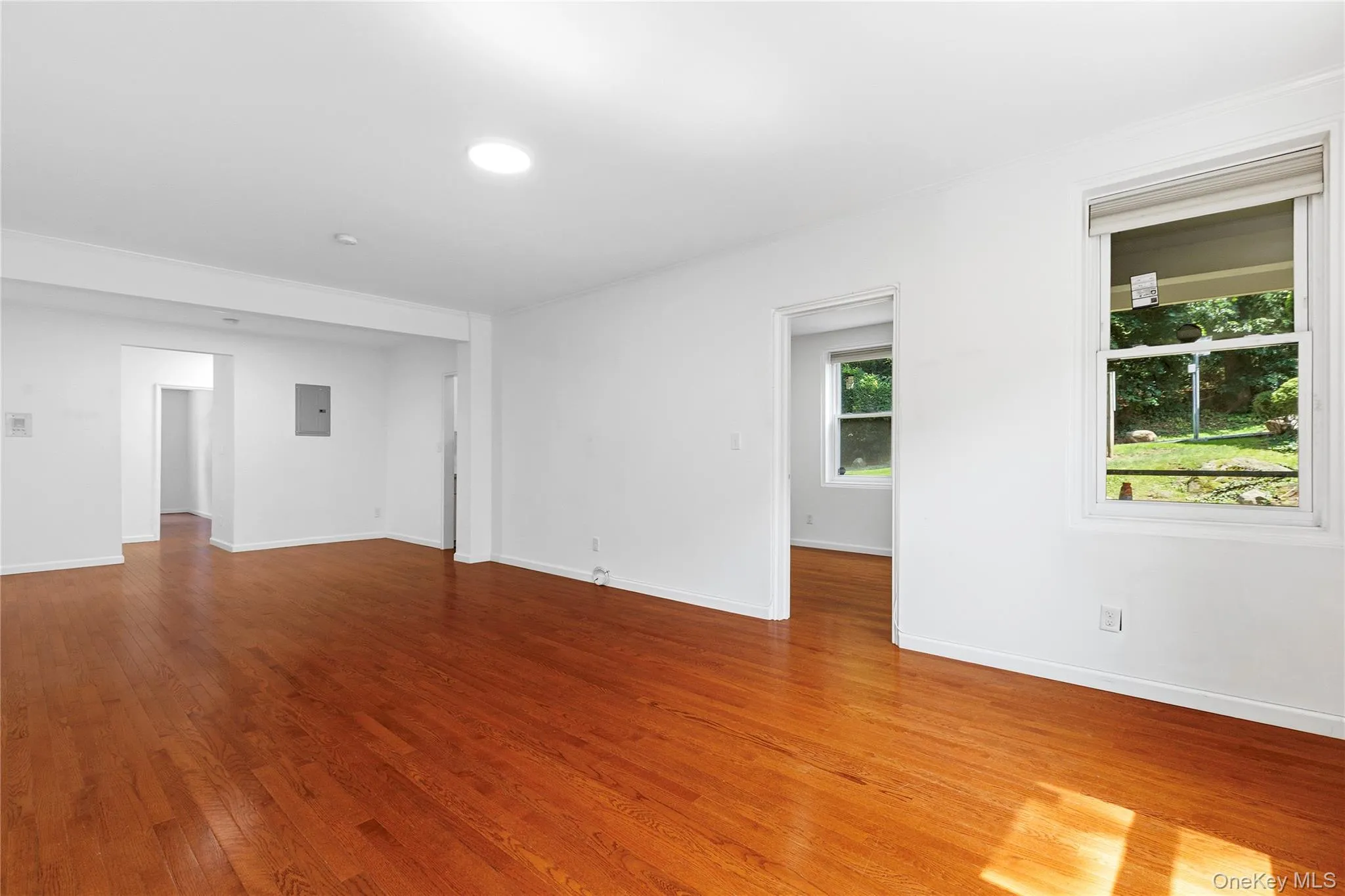 Another view of the spacious living room with beautiful wood floors Another view of the spacious living room with beautiful wood floors