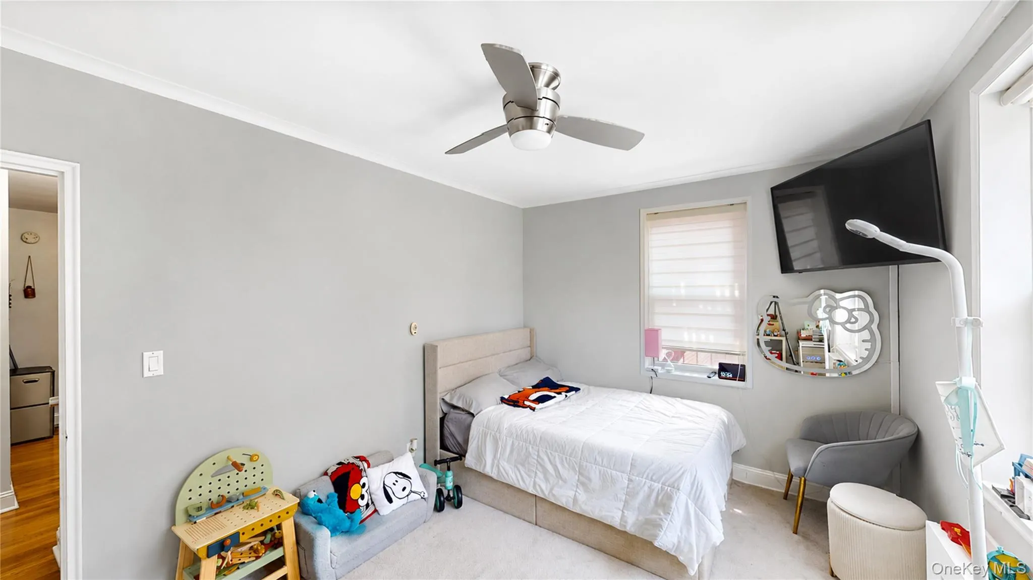 Bedroom featuring crown molding, light gray walls, a window with blinds, and a ceiling fan with integrated lighting Bedroom featuring crown molding, light gray walls, a window with blinds, and a ceiling fan with integrated lighting