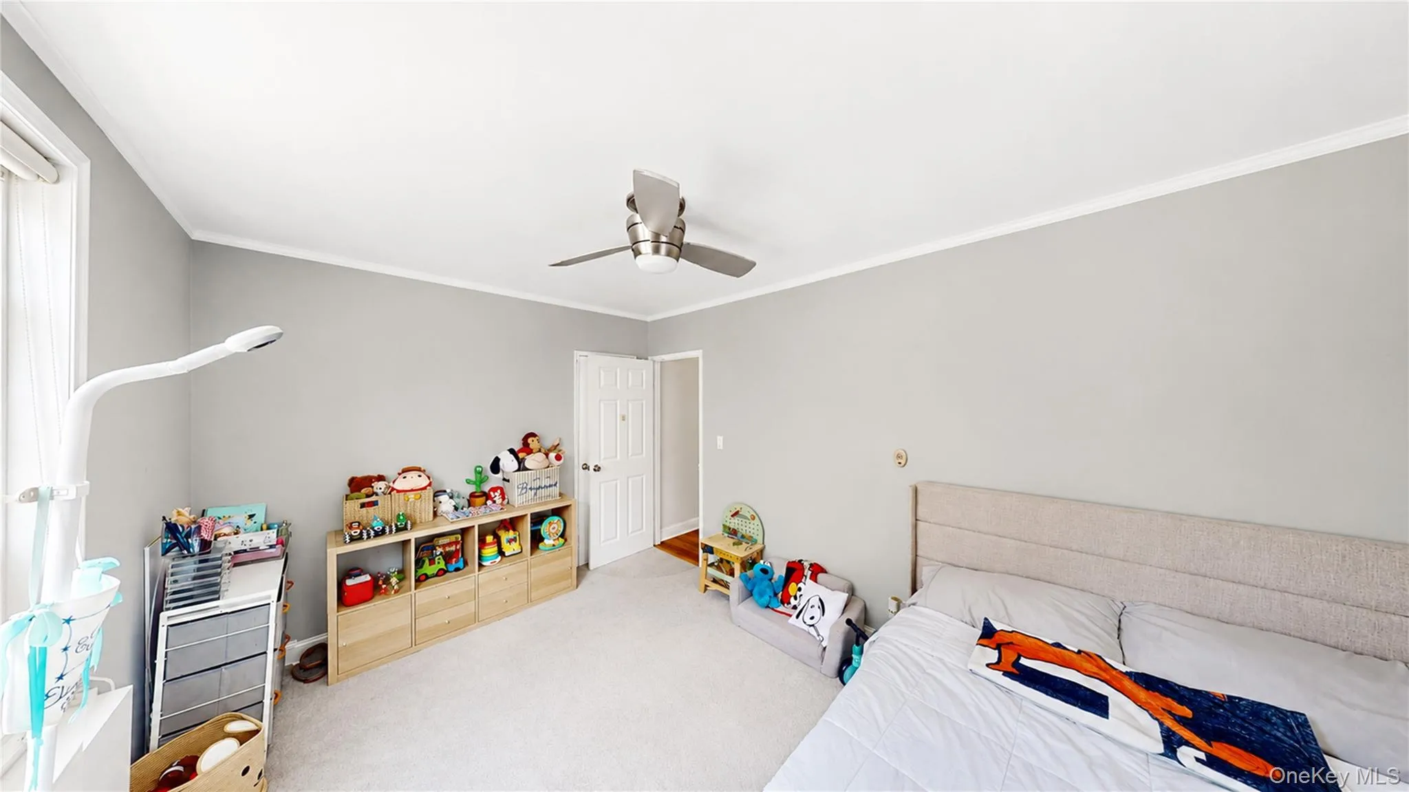 Spacious room with a ceiling fan, light gray wall paint, and white trim Spacious room with a ceiling fan, light gray wall paint, and white trim