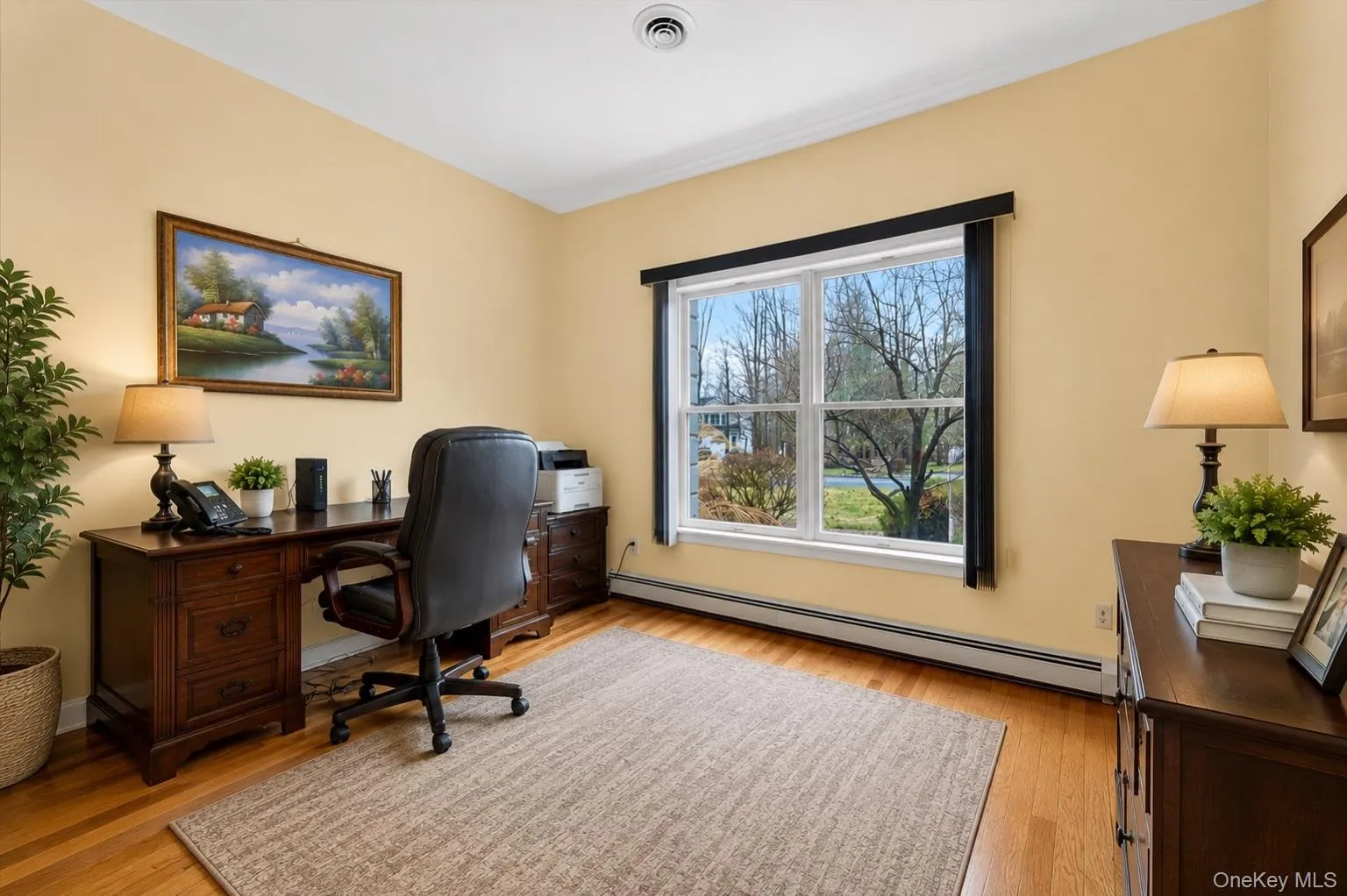 Possible Bedroom with Full bathroom access interior space featuring hardwood flooring and a large window with exterior views Possible Bedroom with Full bathroom access interior space featuring hardwood flooring and a large window with exterior views