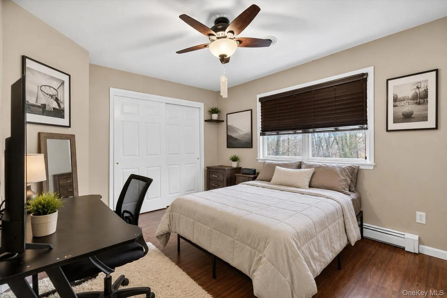 Bedroom featuring wood-finish flooring and neutral wall tones Bedroom featuring wood-finish flooring and neutral wall tones
