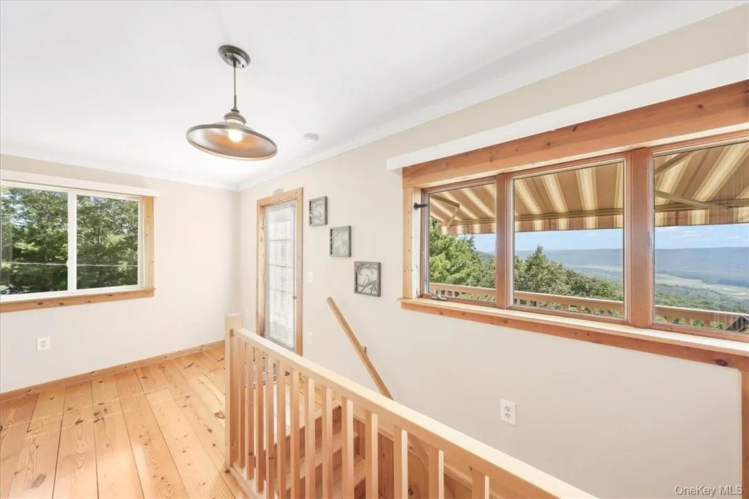 Sitting area with Windows overlooking the Bashakill Reserve. Door to Deck with an awing Sitting area with Windows overlooking the Bashakill Reserve. Door to Deck with an awing