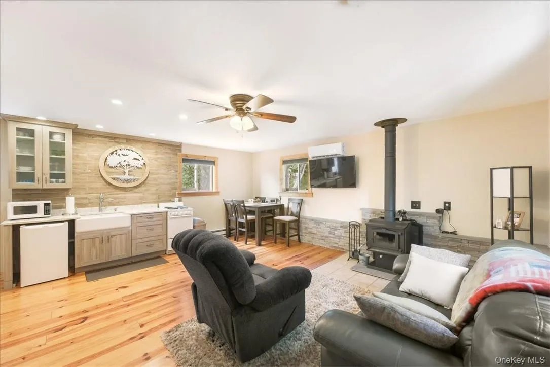 Gleaming pine floors, NEW Kitchen, OPEN LIVING AREA with Split units for Efficient Cooling & heating. Plus a wood stove that OFFERS Cozy ambiance and toasty Warmth. Furniture included in the purchase Gleaming pine floors, NEW Kitchen, OPEN LIVING AREA with Split units for Efficient Cooling & heating. Plus a wood stove that OFFERS Cozy ambiance and toasty Warmth. Furniture included in the purchase
