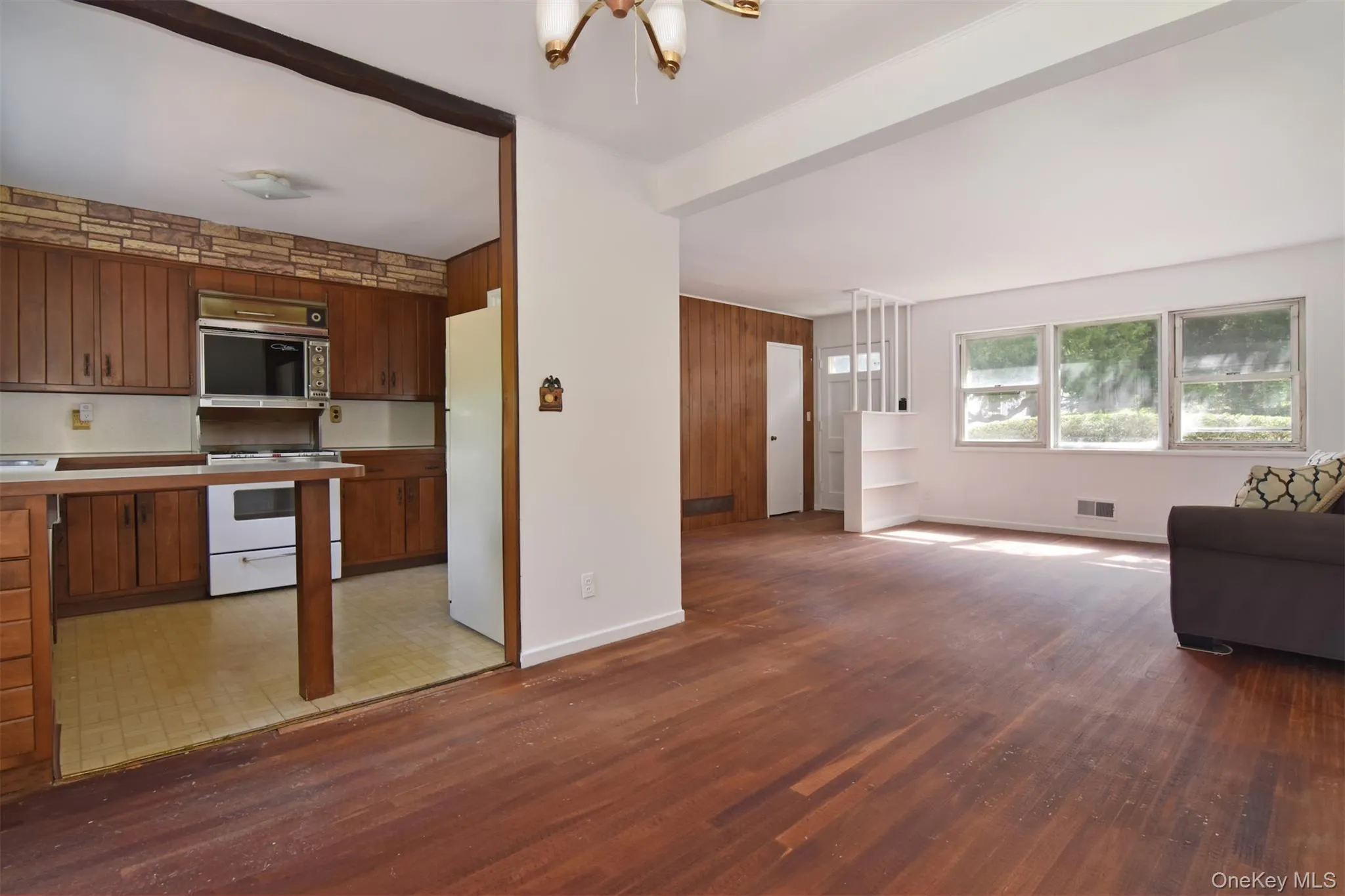Hardwood floors throughout. A view into the living room from the dining area. Hardwood floors throughout. A view into the living room from the dining area.