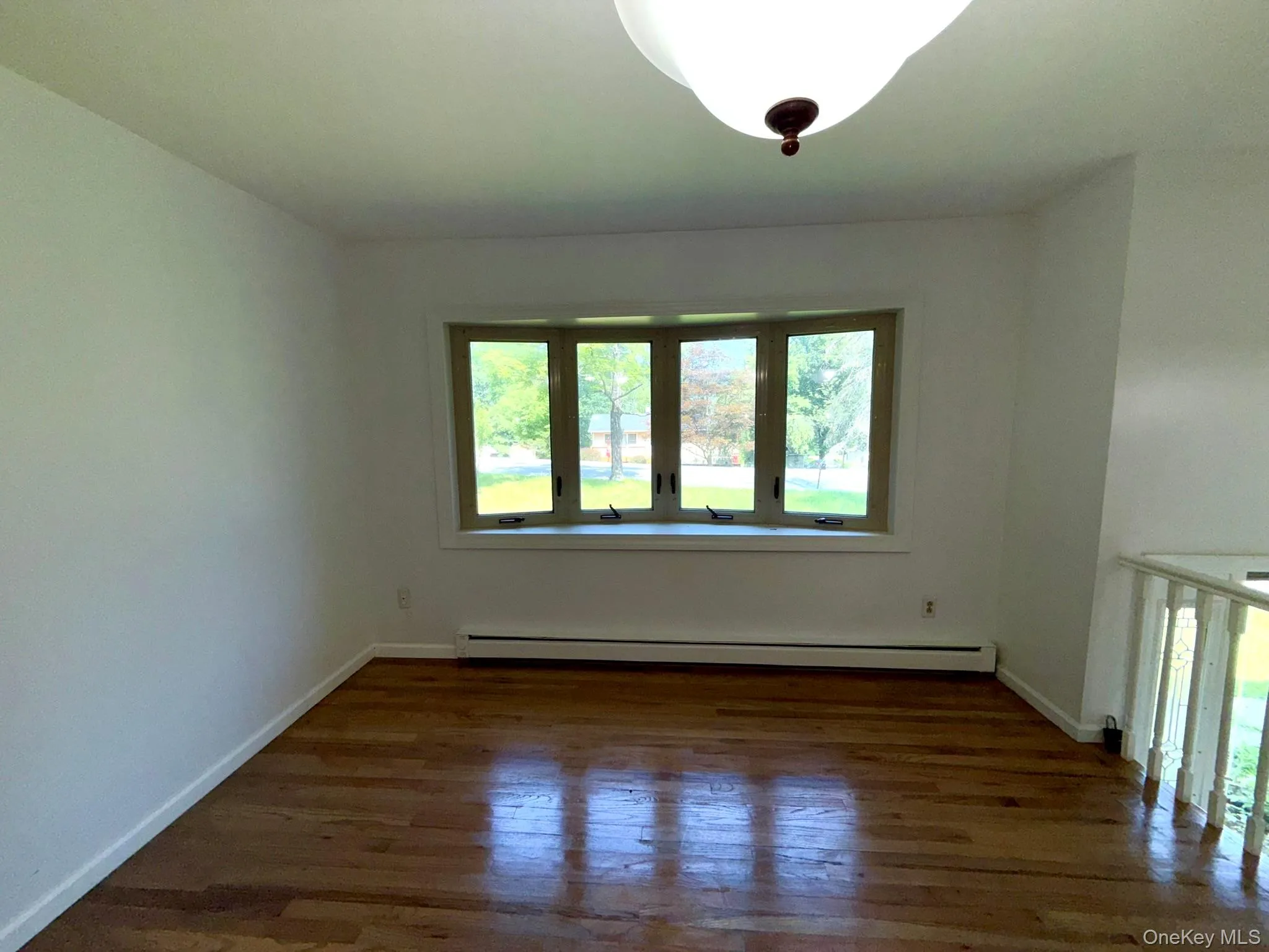 Beautiful hardwood floors and a bow window overlooking the front of the property. Beautiful hardwood floors and a bow window overlooking the front of the property.