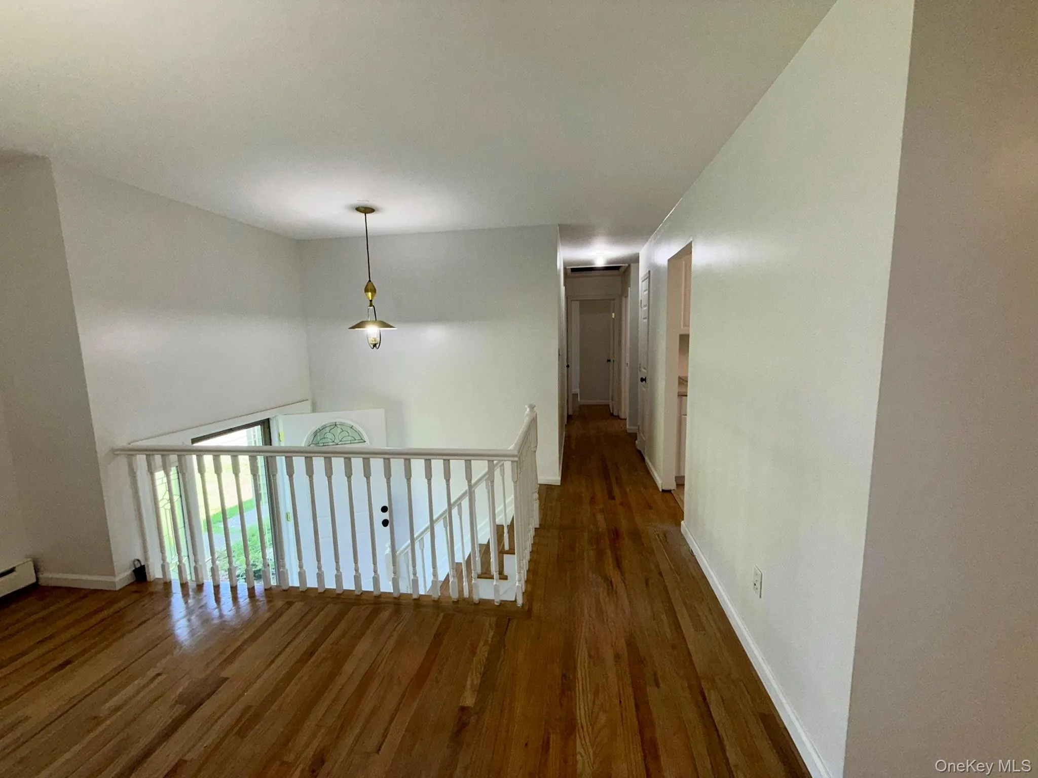 Spacious living room with a welcoming view toward the foyer, which provides access to the bathroom and three bedrooms Spacious living room with a welcoming view toward the foyer, which provides access to the bathroom and three bedrooms