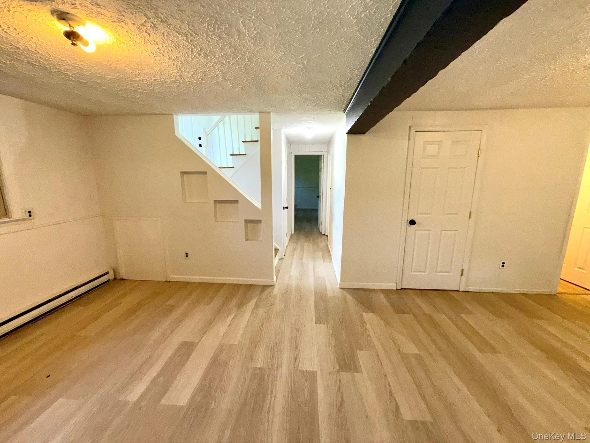 On the left, hallway leading to 4th bedroom and garage, laundry room in the middle, 1/2 bath on the right On the left, hallway leading to 4th bedroom and garage, laundry room in the middle, 1/2 bath on the right