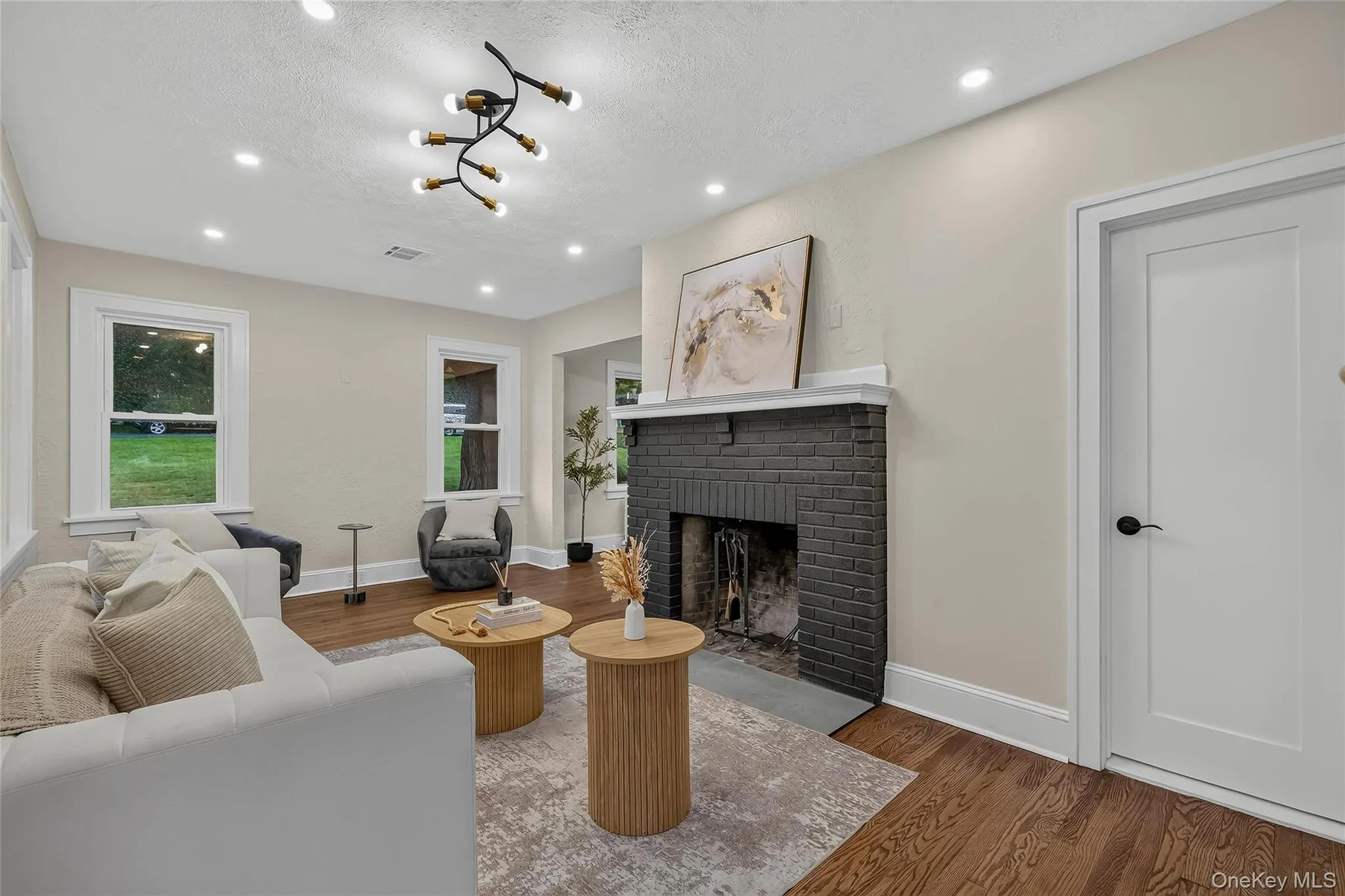 Living area with a painted brick fireplace, white mantel, and slate hearth Living area with a painted brick fireplace, white mantel, and slate hearth
