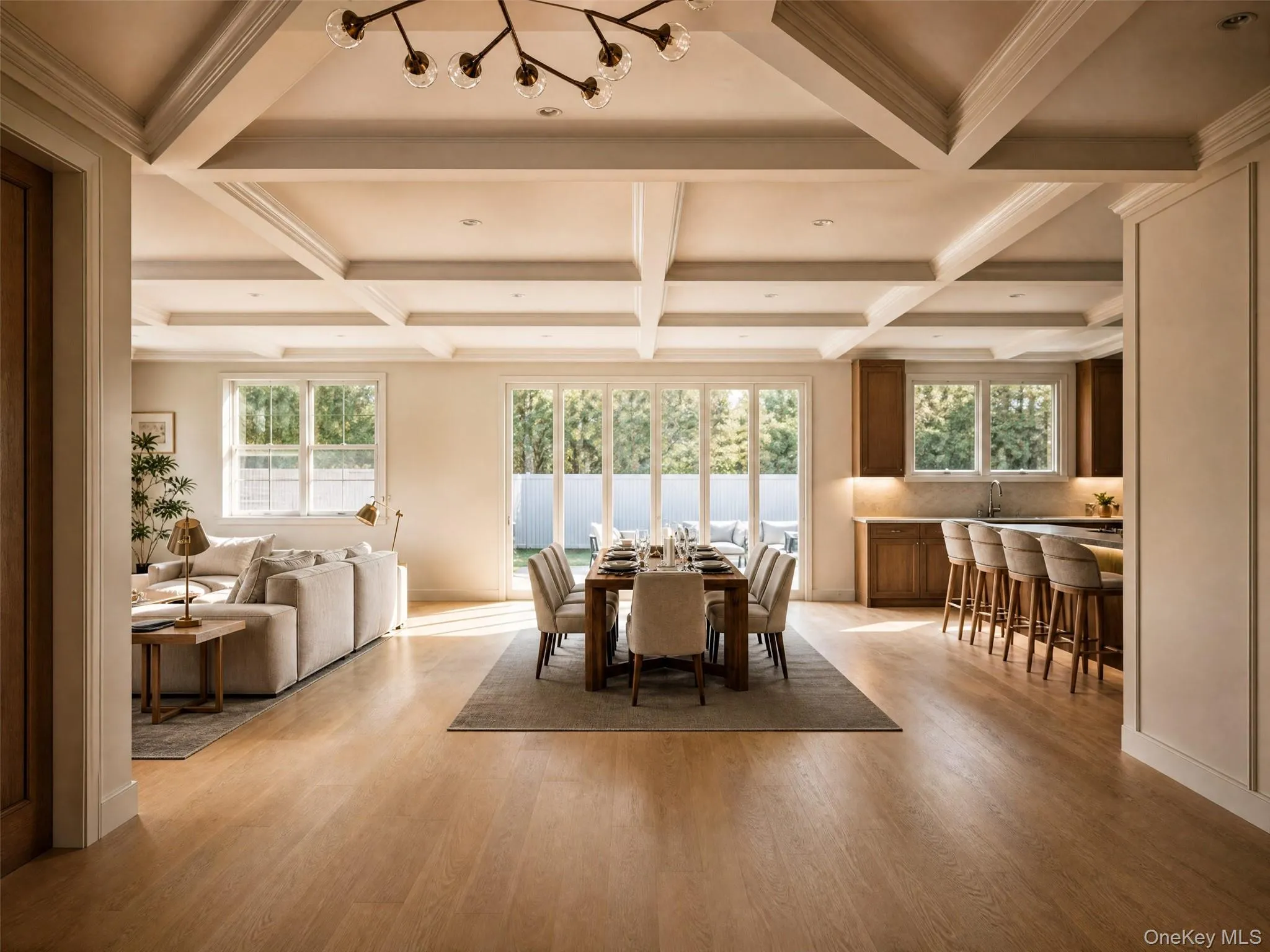 Spacious open-concept interior featuring light wood-finish flooring and an intricate coffered ceiling Spacious open-concept interior featuring light wood-finish flooring and an intricate coffered ceiling