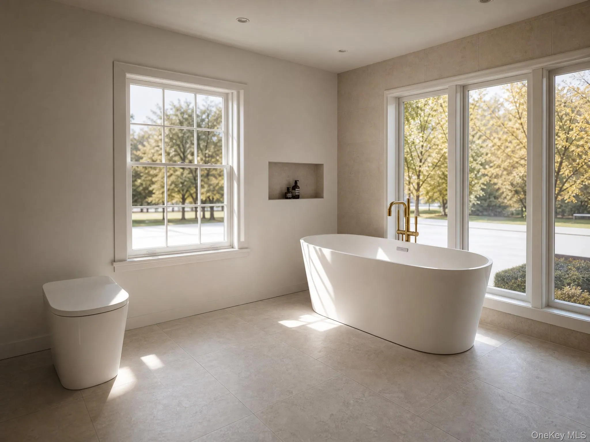 Freestanding soaking tub with a floor-mounted gold-tone faucet, complemented by large format tile flooring Freestanding soaking tub with a floor-mounted gold-tone faucet, complemented by large format tile flooring