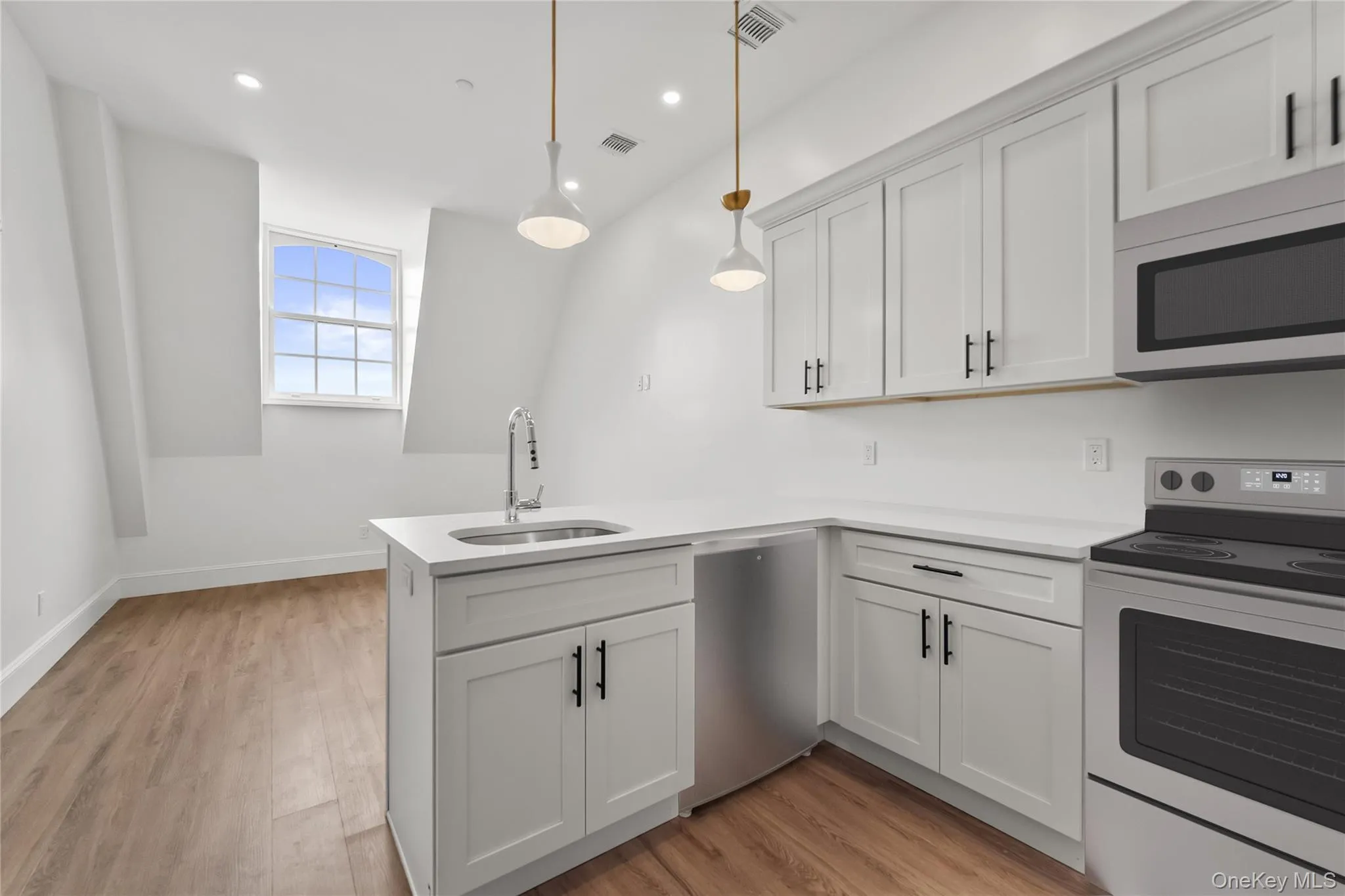 Kitchen with a large Island and stainless steel appliances Kitchen with a large Island and stainless steel appliances