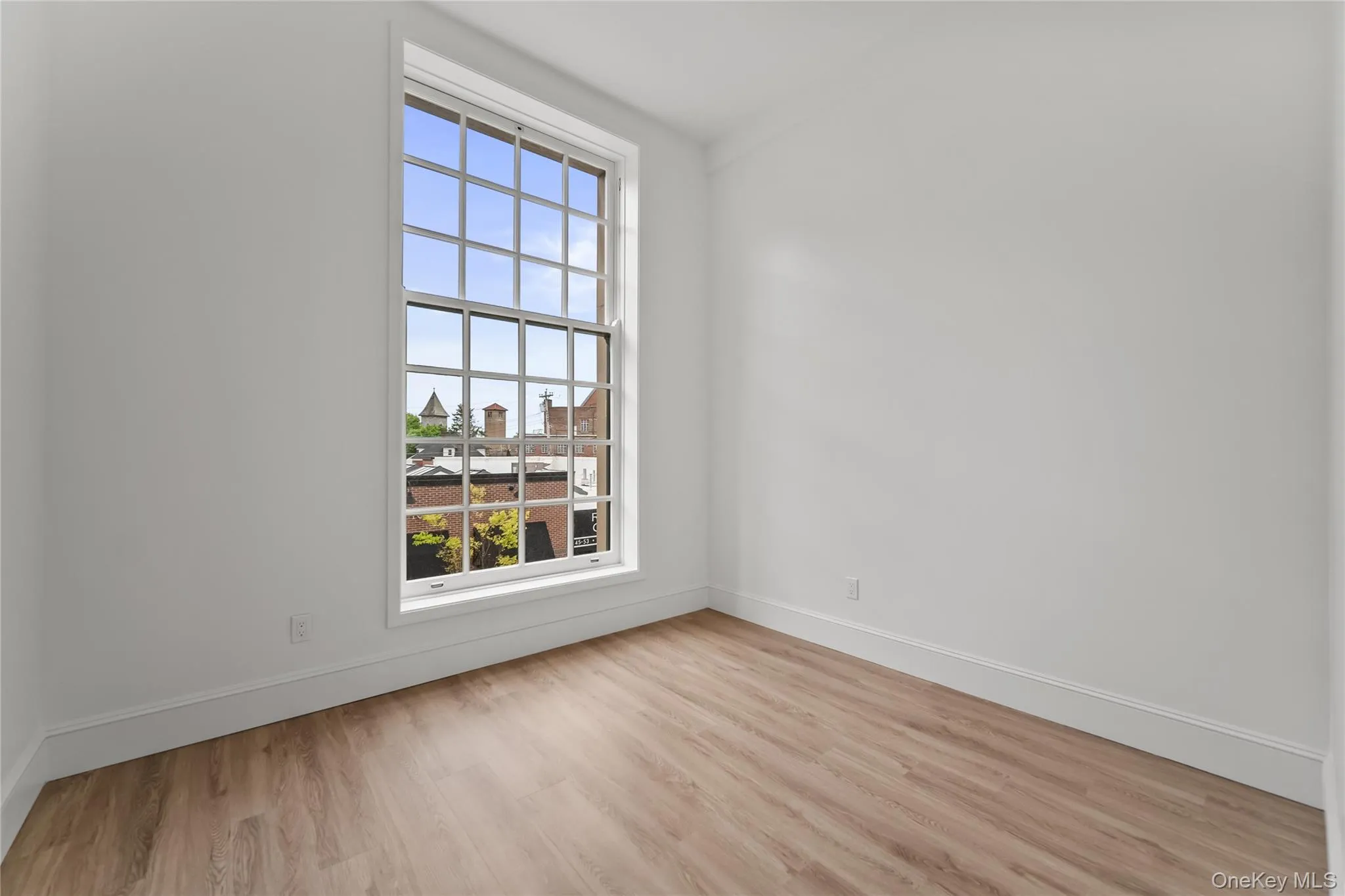 Bedroom with high ceilings and large window Bedroom with high ceilings and large window