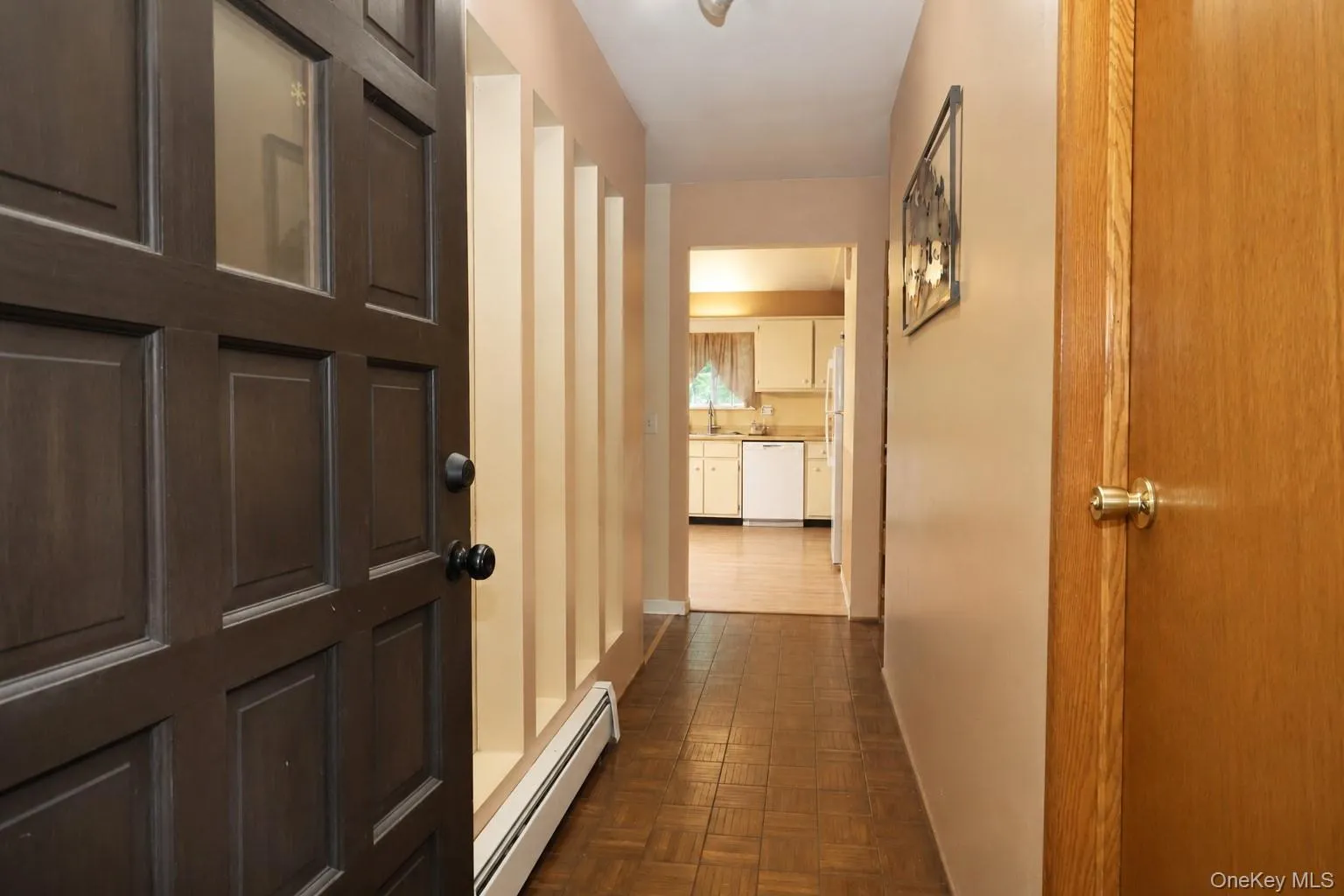 Entryway featuring a dark paneled front door with clear glass inserts, tile flooring, and a decorative wall partition Entryway featuring a dark paneled front door with clear glass inserts, tile flooring, and a decorative wall partition