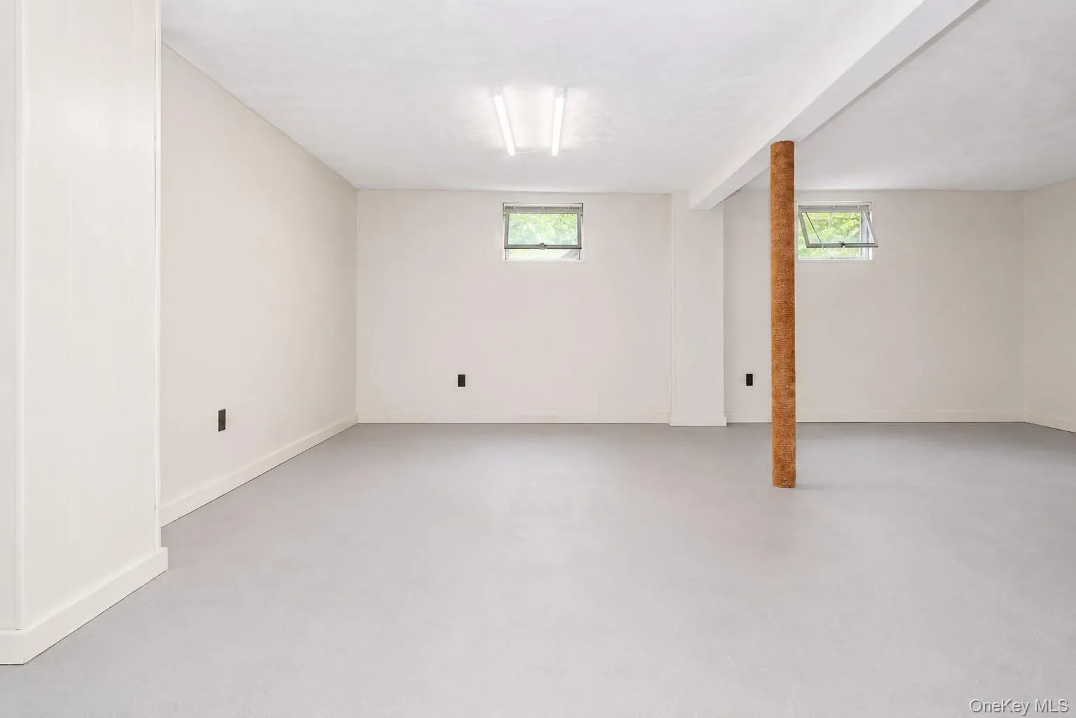 Spacious lower level featuring light-colored walls and a neutral floor Spacious lower level featuring light-colored walls and a neutral floor