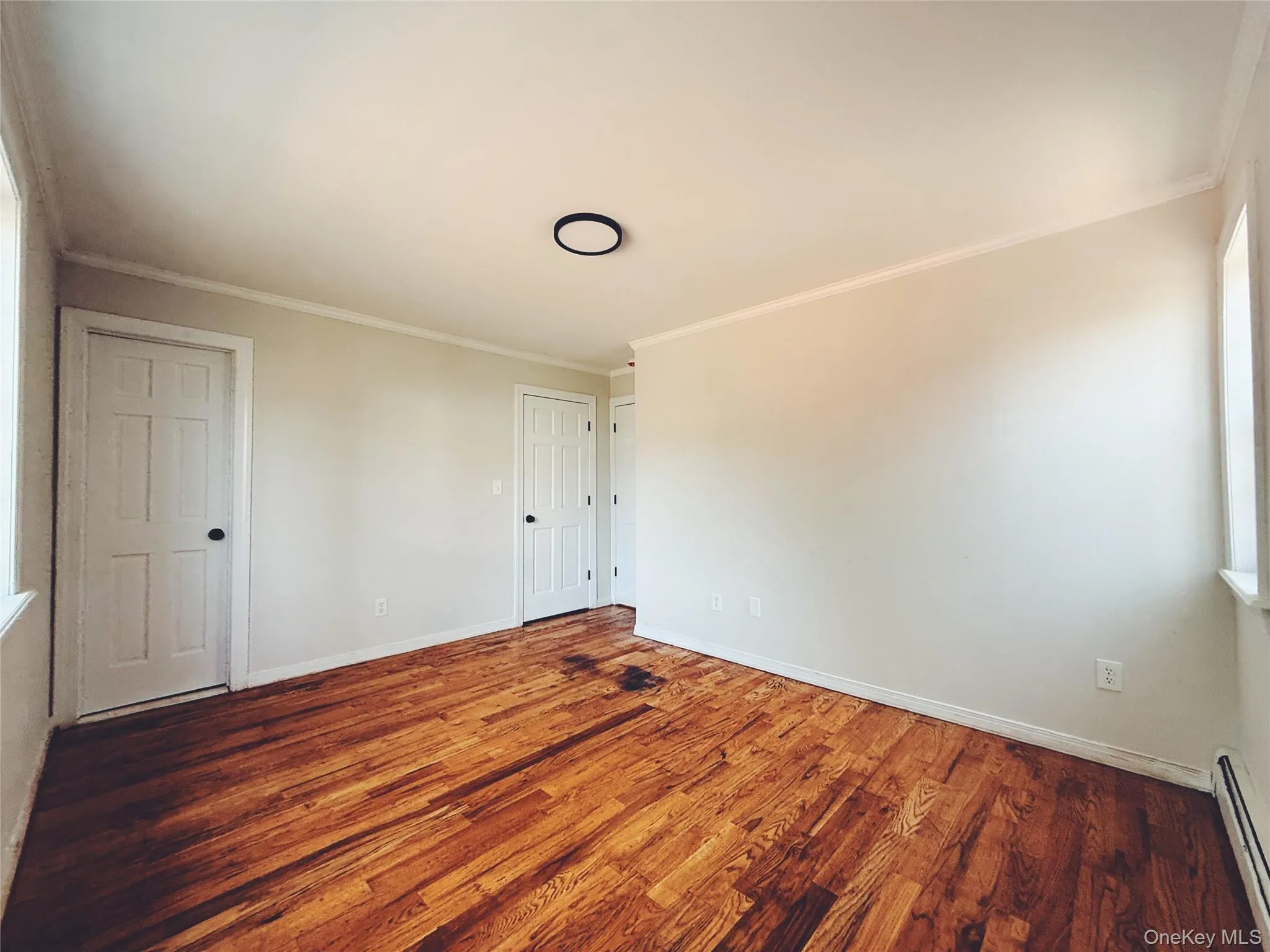 Hardwood flooring, a large window with natural light, closet, and private bathroom. Hardwood flooring, a large window with natural light, closet, and private bathroom.