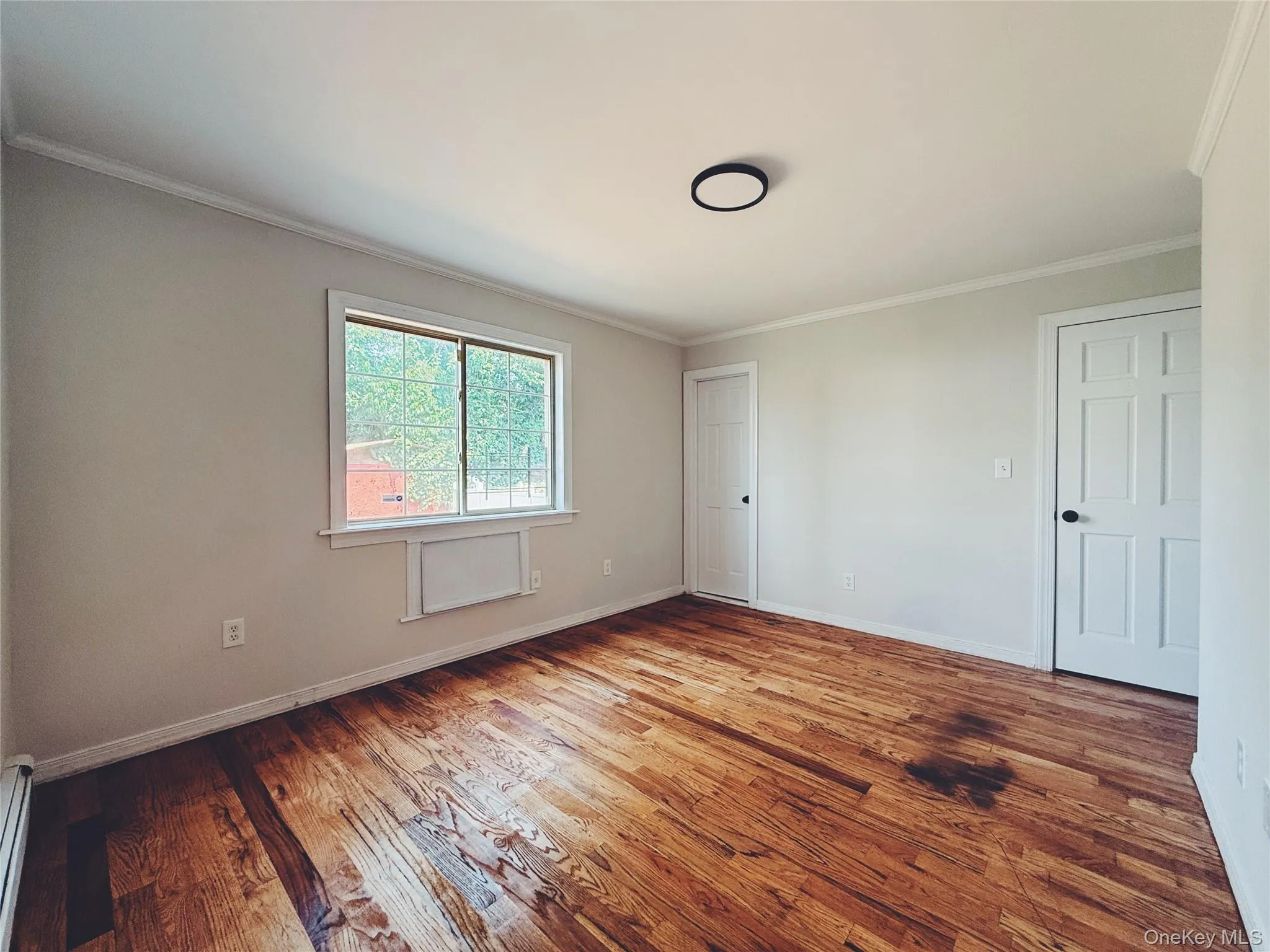 Hardwood flooring, a large window with natural light, closet, and private bathroom. Hardwood flooring, a large window with natural light, closet, and private bathroom.