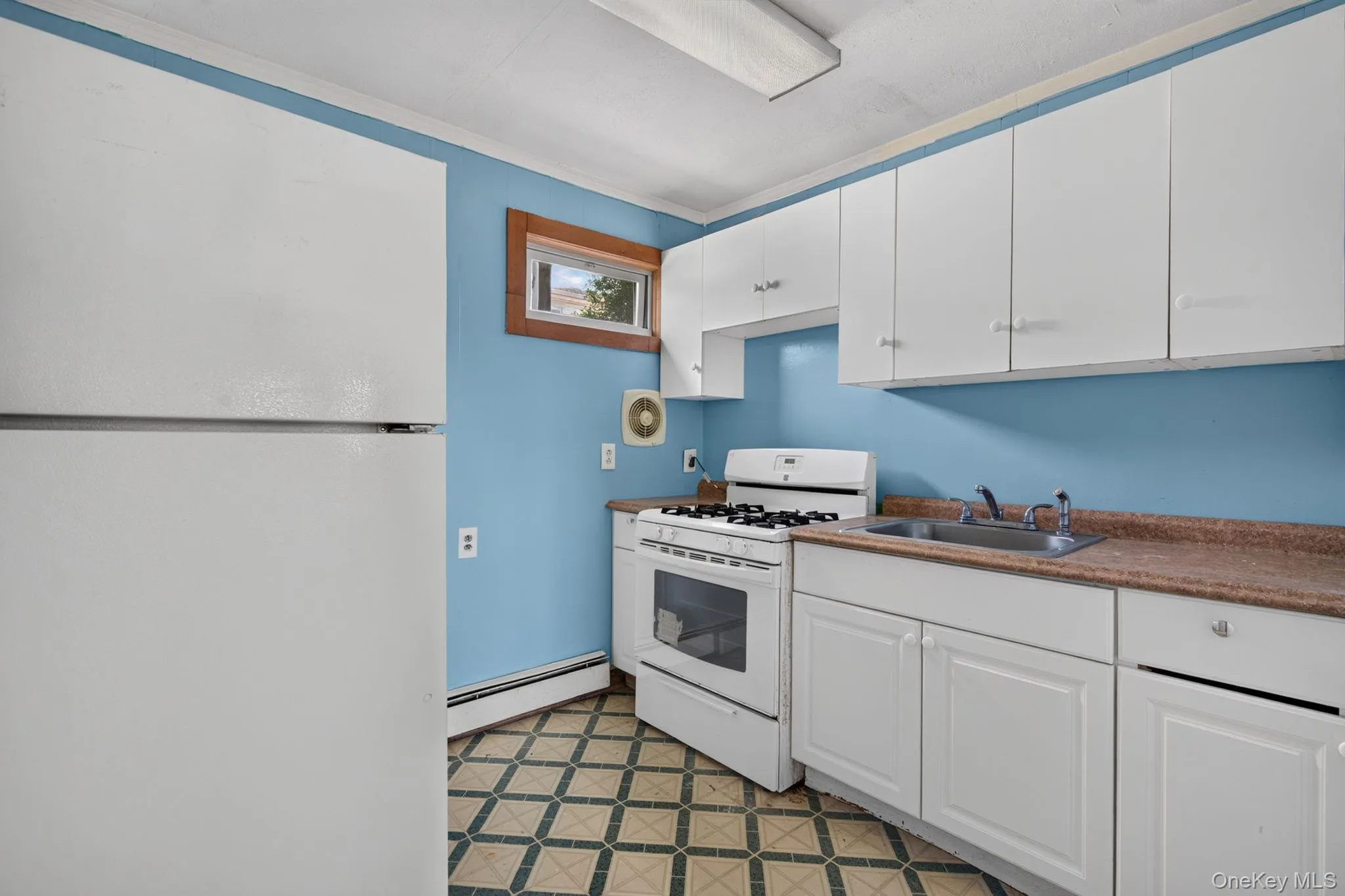 1st Floor Kitchen featuring white cabinetry, a stainless steel sink, and a gas range 1st Floor Kitchen featuring white cabinetry, a stainless steel sink, and a gas range