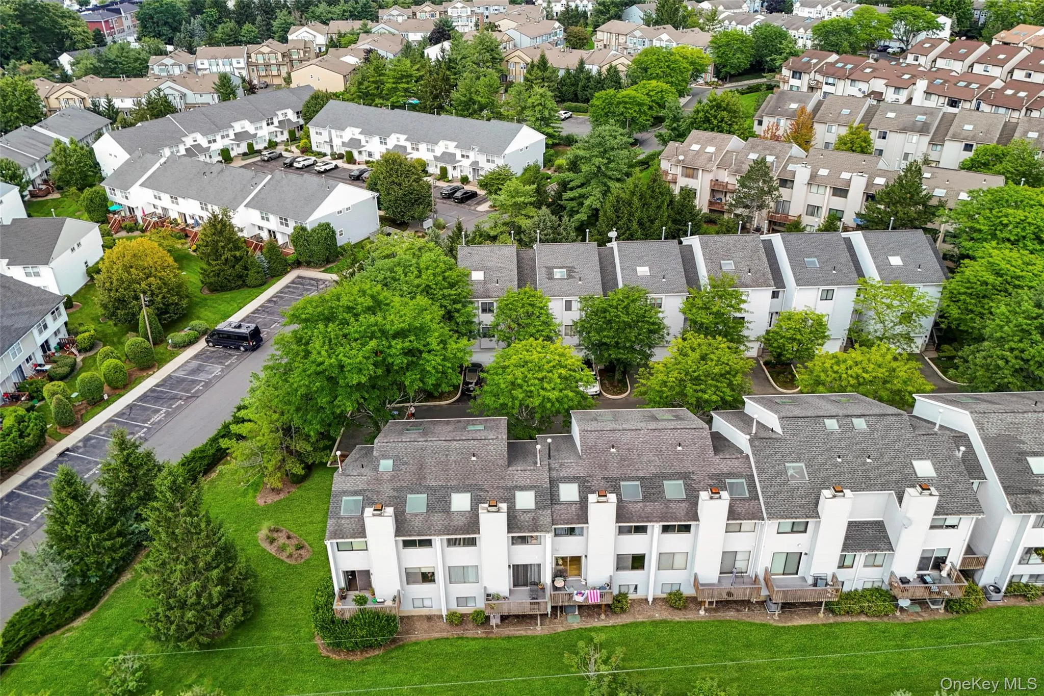Additional Visitor Parking on Vista Dr. Aerial view of 59 Chester Ln left of townhouse with towels hanging over deck railing, Additional Visitor Parking on Vista Dr. Aerial view of 59 Chester Ln left of townhouse with towels hanging over deck railing,