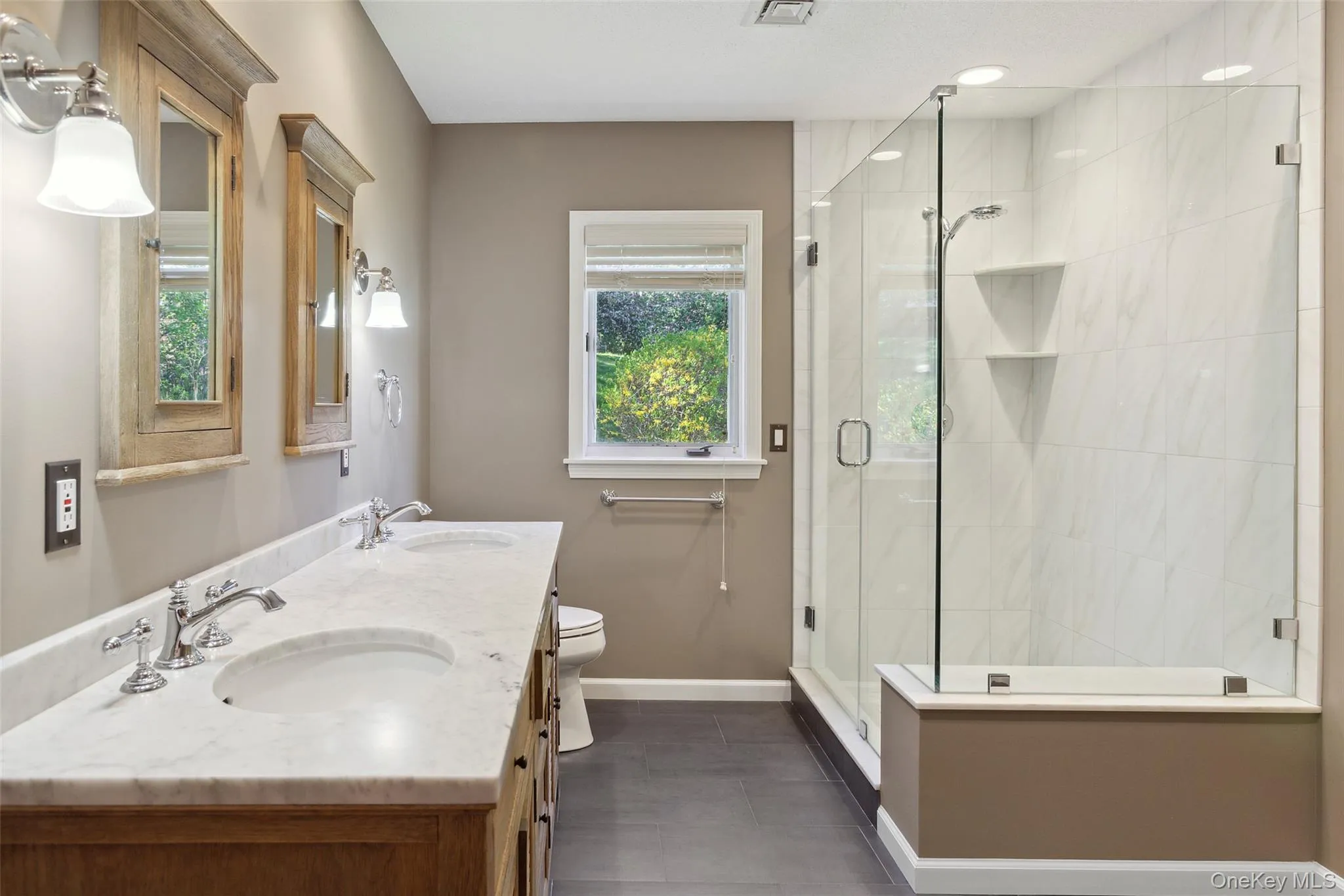 Full bathroom with a sink, baseboards, and a shower stall Full bathroom with a sink, baseboards, and a shower stall