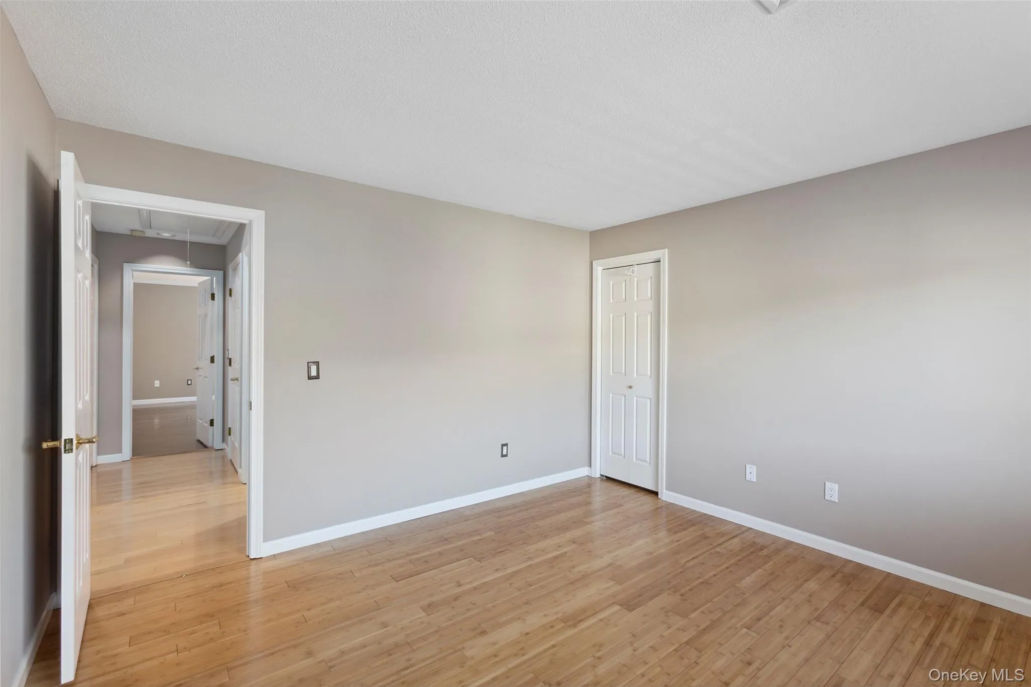 Unfurnished room with baseboards, attic access, and light wood finished floors Unfurnished room with baseboards, attic access, and light wood finished floors