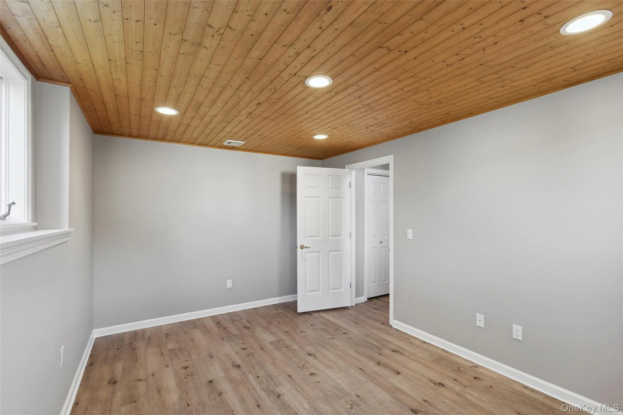 Spare room with recessed lighting, light wood-style flooring, and wooden ceiling Spare room with recessed lighting, light wood-style flooring, and wooden ceiling