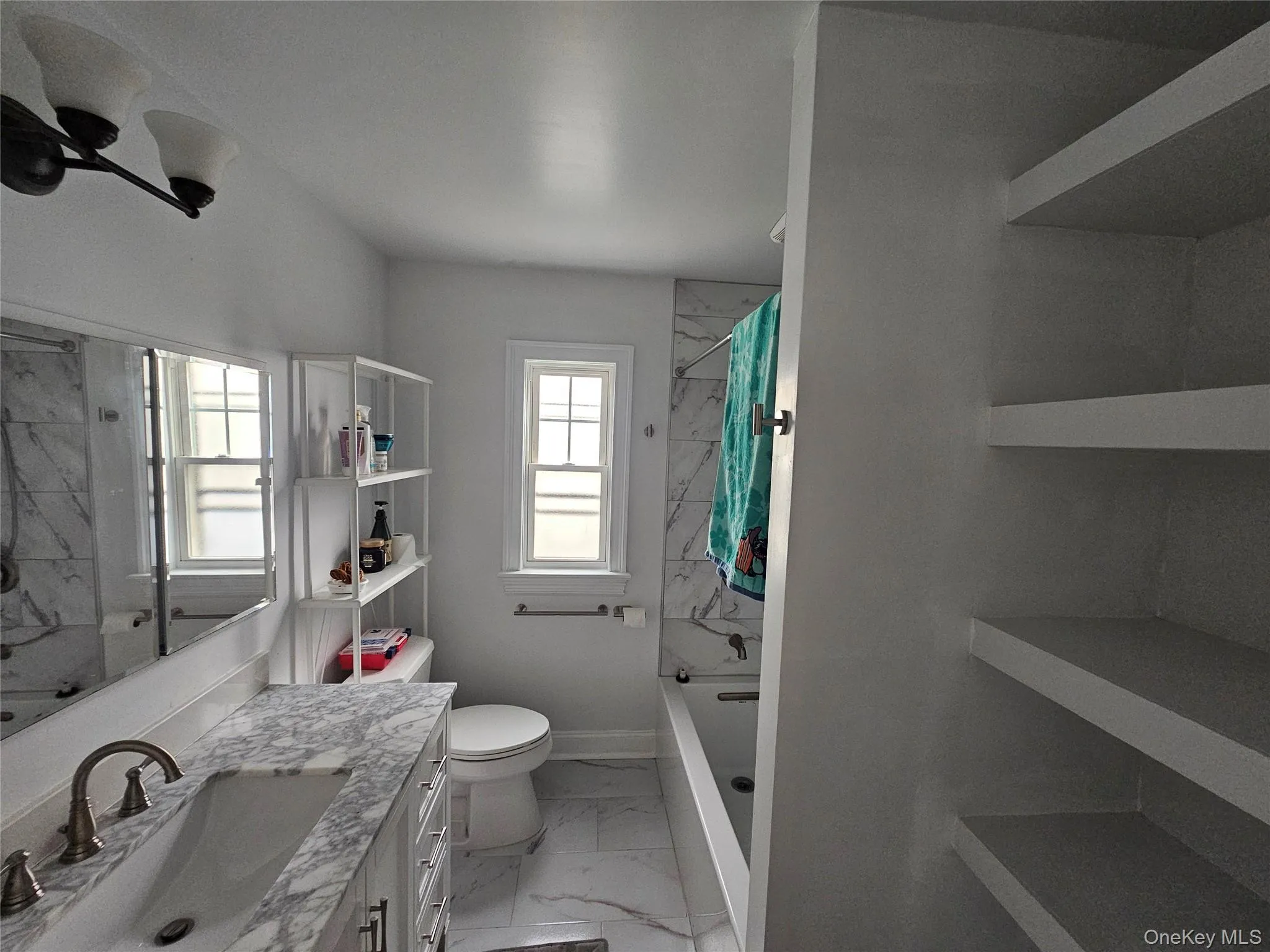 Updated bathroom with built-in shelving. Updated bathroom with built-in shelving.