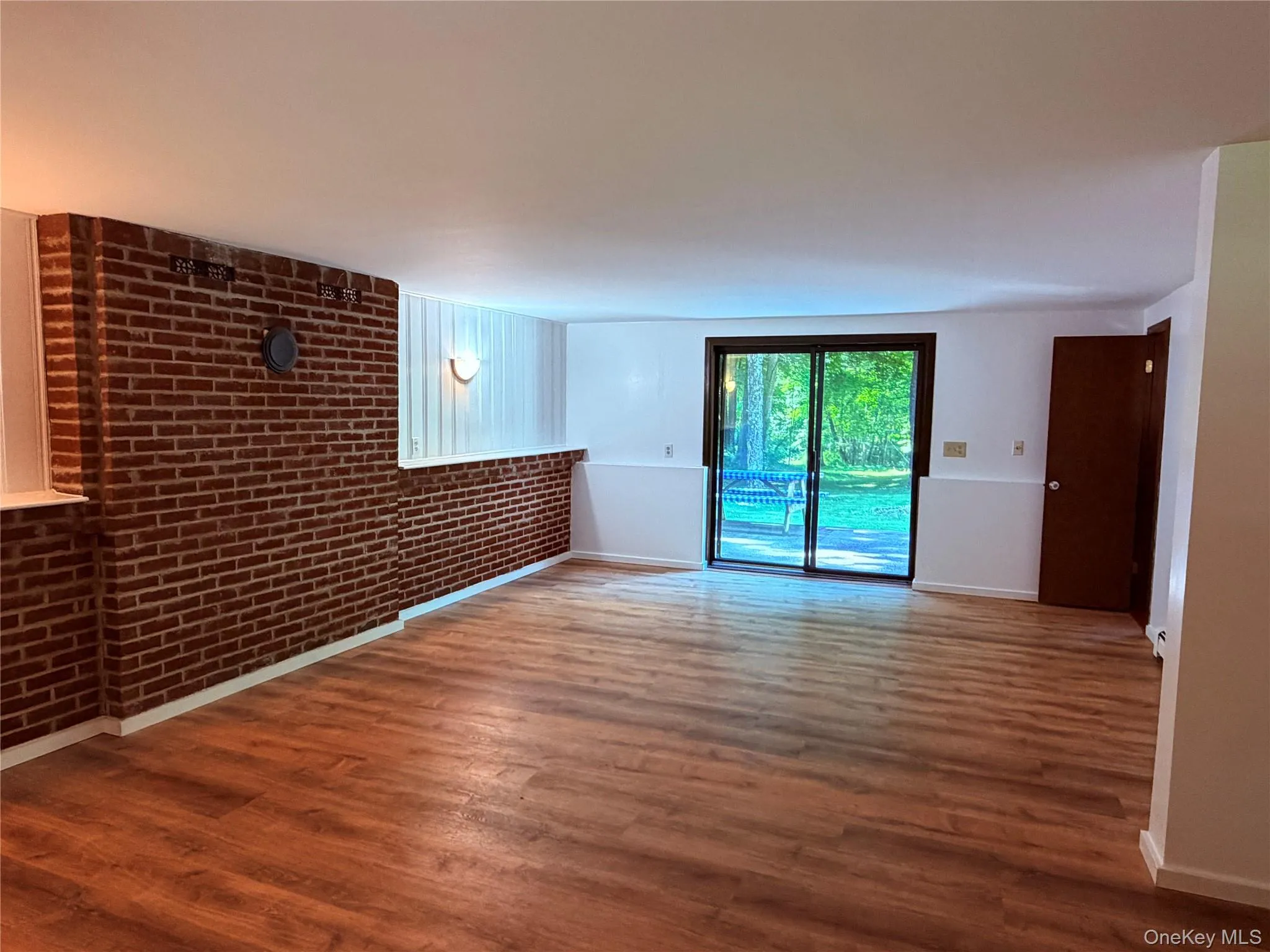 Lower level with gleaming newly refinished HWF, powder room and sliders to the patio Lower level with gleaming newly refinished HWF, powder room and sliders to the patio