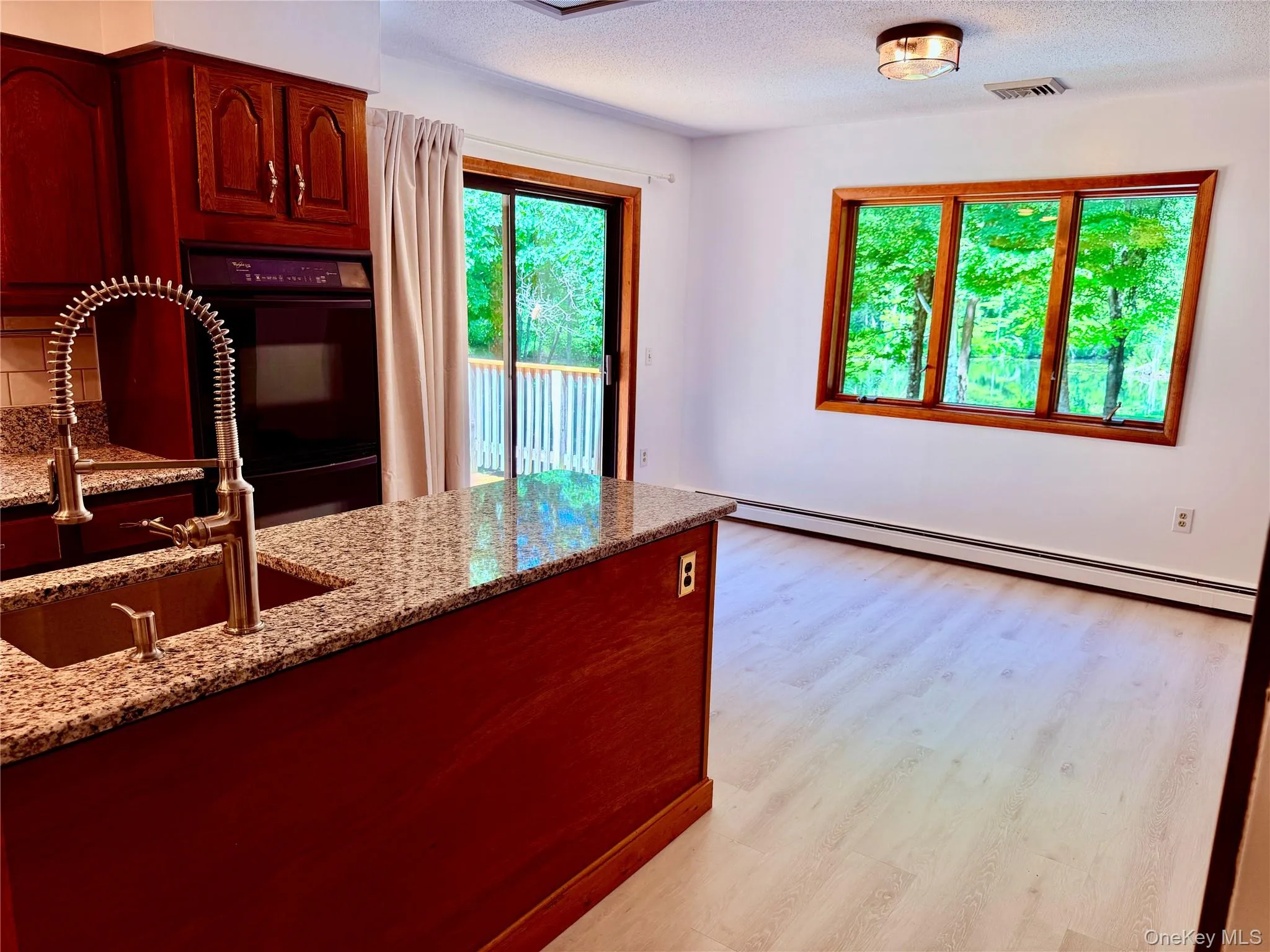 With windows and sliders to large deck and beautiful private backyard With windows and sliders to large deck and beautiful private backyard