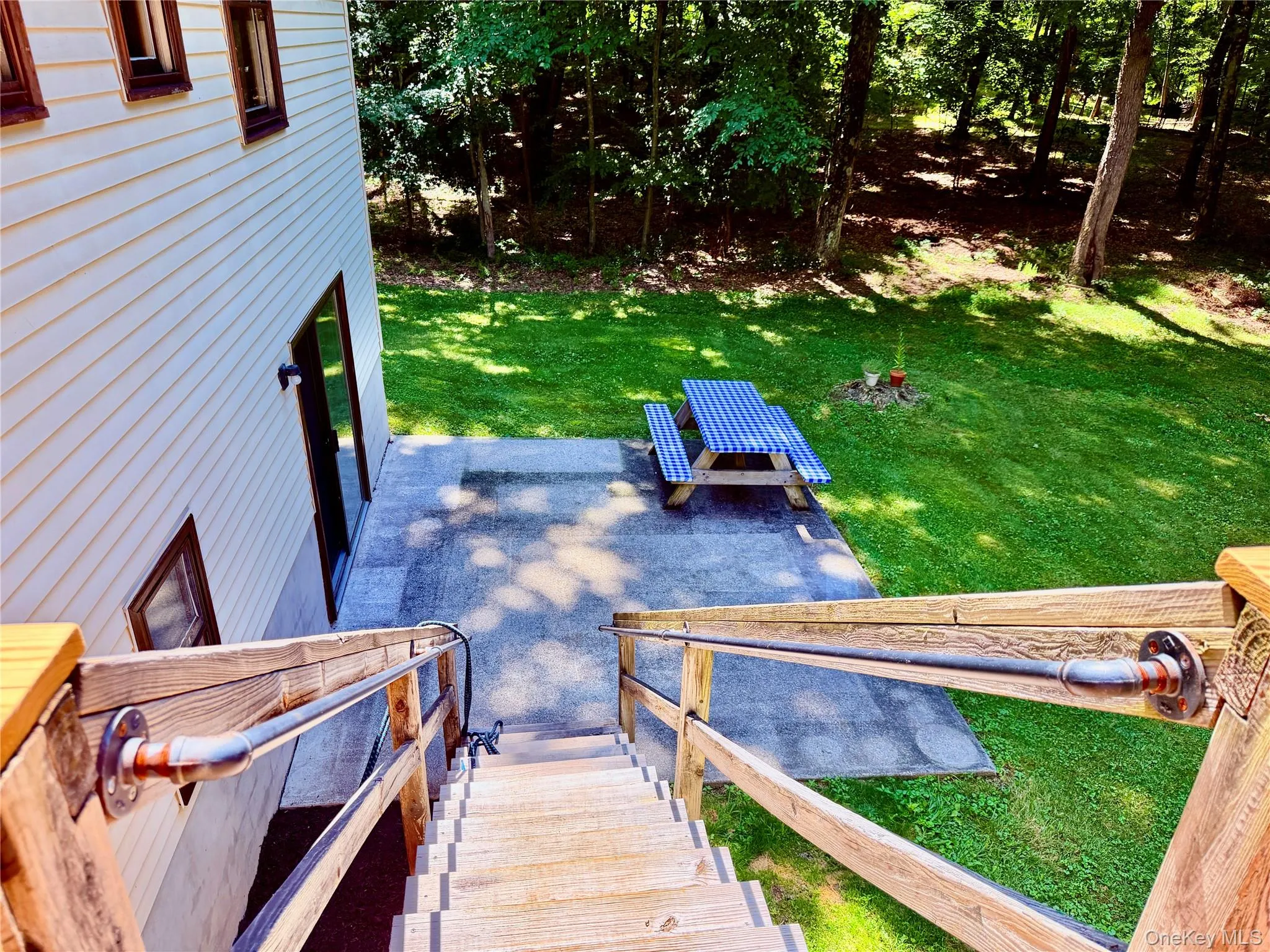 With stairs leading to the downstairs patio. With stairs leading to the downstairs patio.