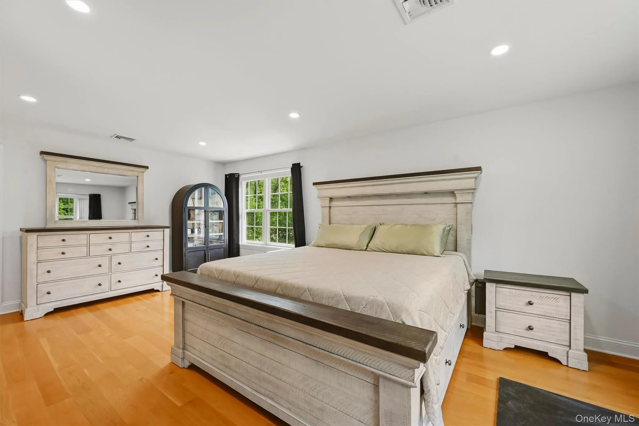 15x19 Primary Bedroom with recessed lighting, wide oak flooring and balcony access. 15x19 Primary Bedroom with recessed lighting, wide oak flooring and balcony access.